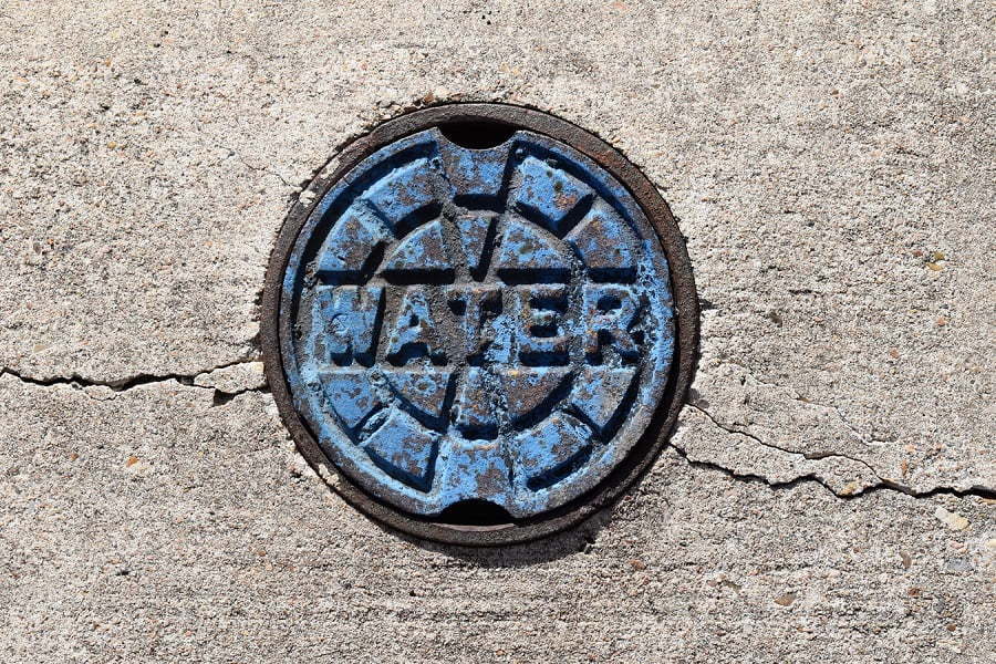 manhole cover asphalt cracked