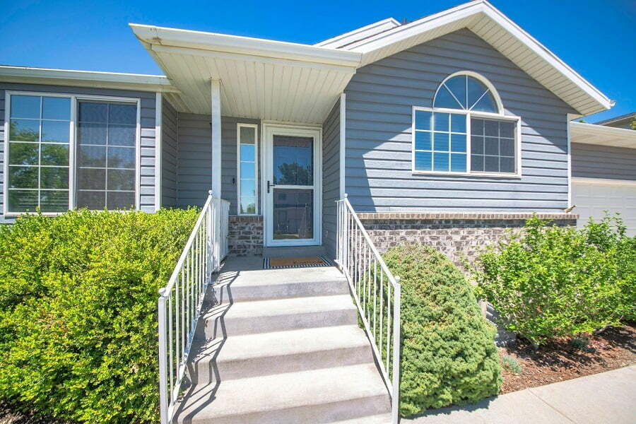 Stairs leading to a home entrance with a storm door