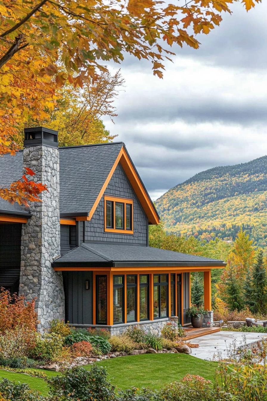 modern cottage style mountain house facade with stone grey siding orange trim stone chimney maple trees in the yard green mountain range in the background in autumn 2