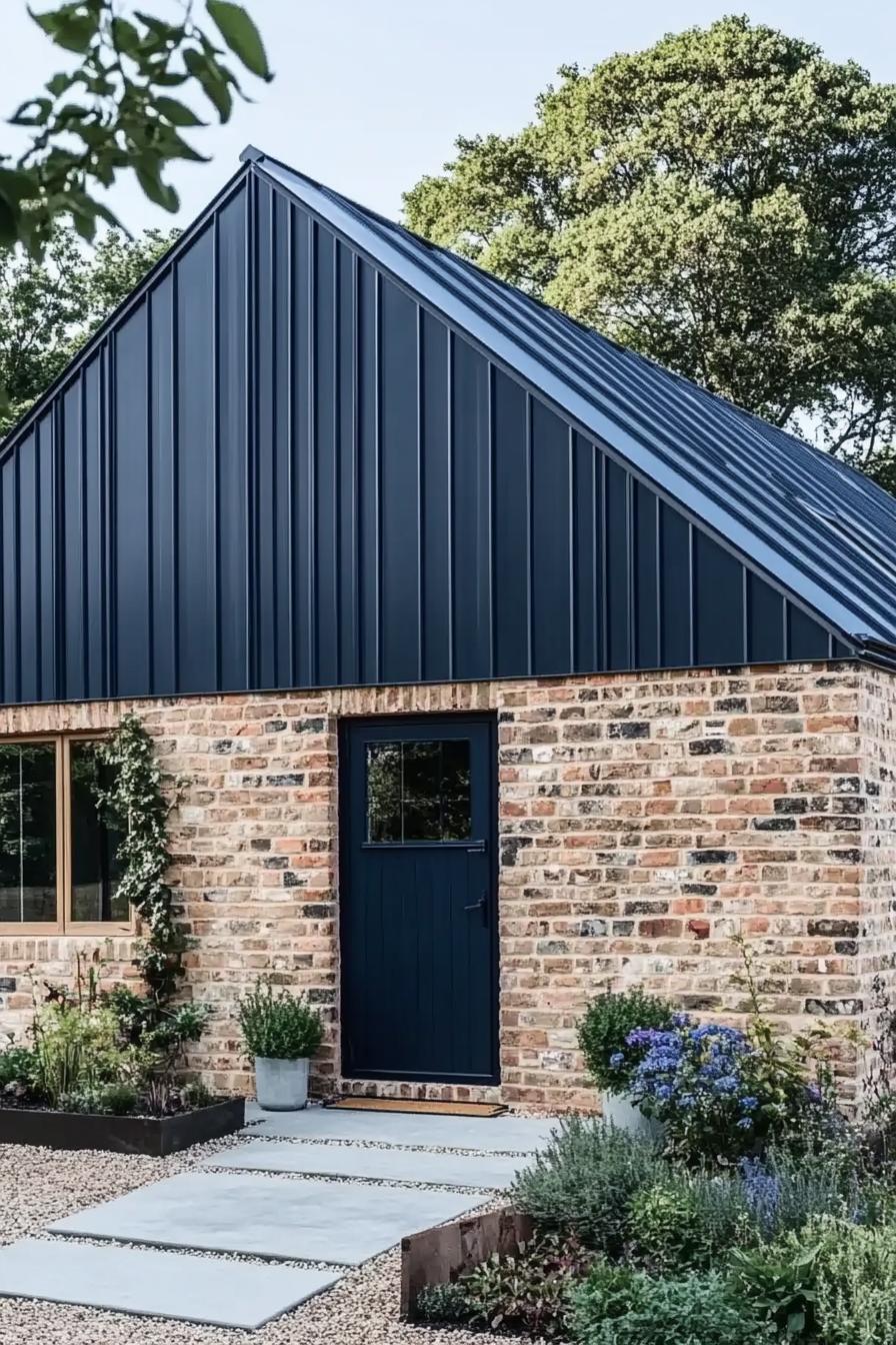 Modern barn house with a black metal roof and brick walls