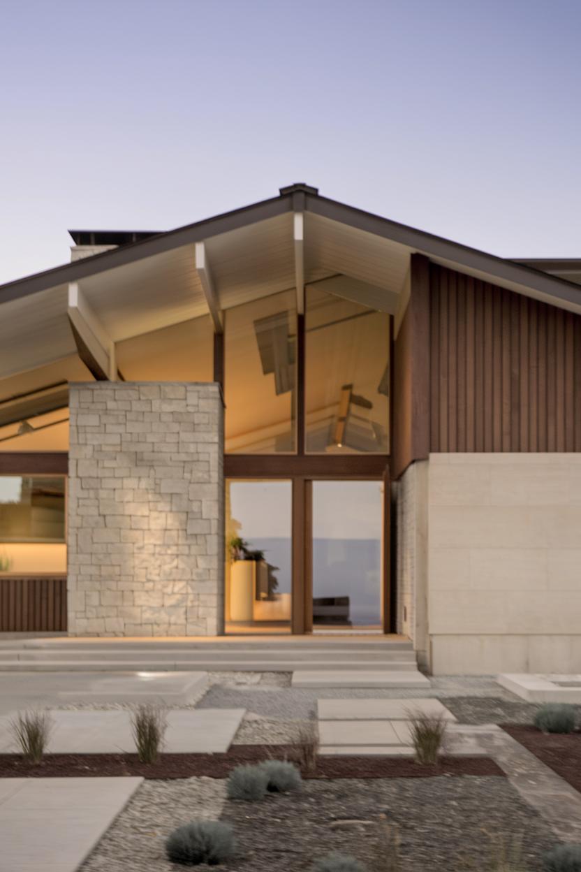 Modern mid-century ranch home with stone and glass facade