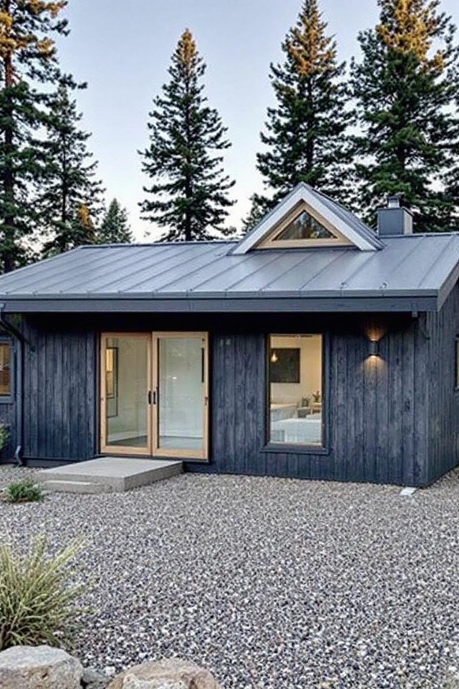 Small modern cabin with a metal roof and triangular window