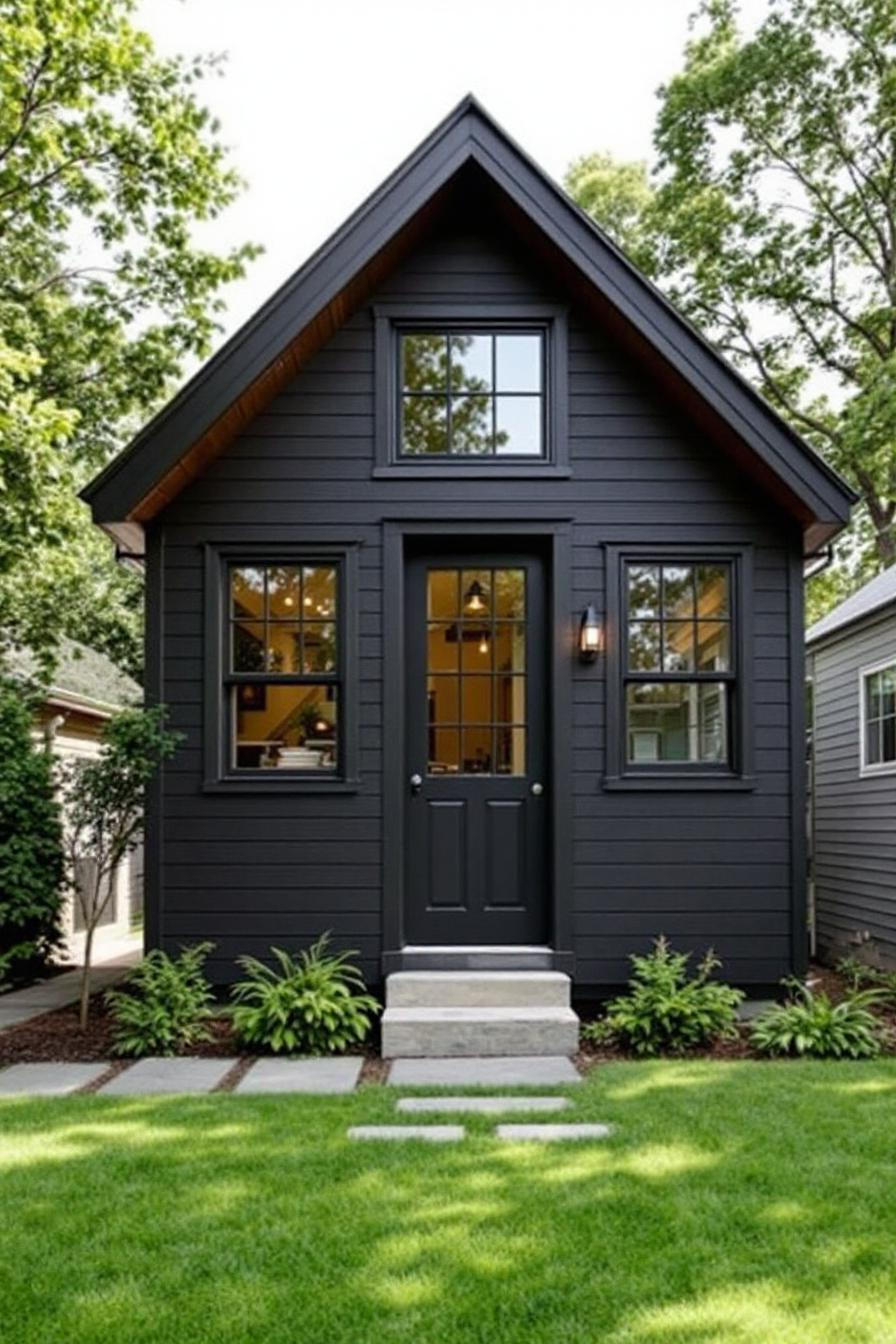 Charming small house with dark siding in a green setting