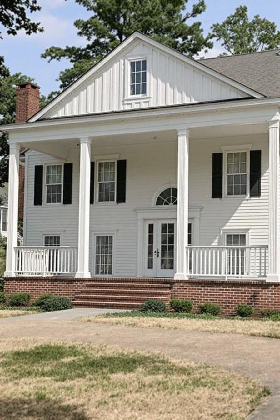 White Southern house with large columns and black shutters