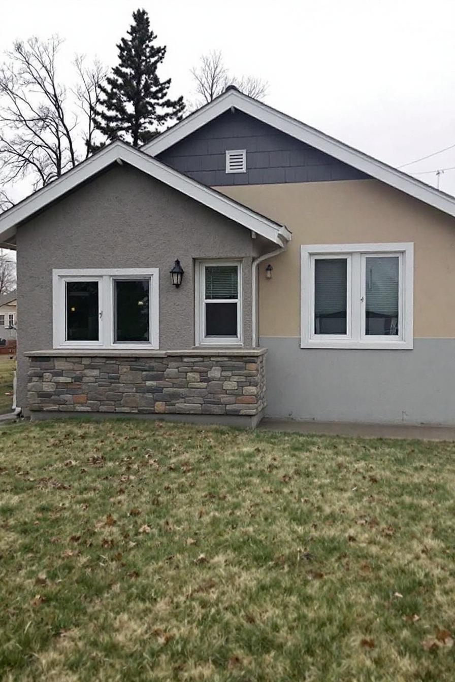 Cozy bungalow with stone accents and grassy lawn
