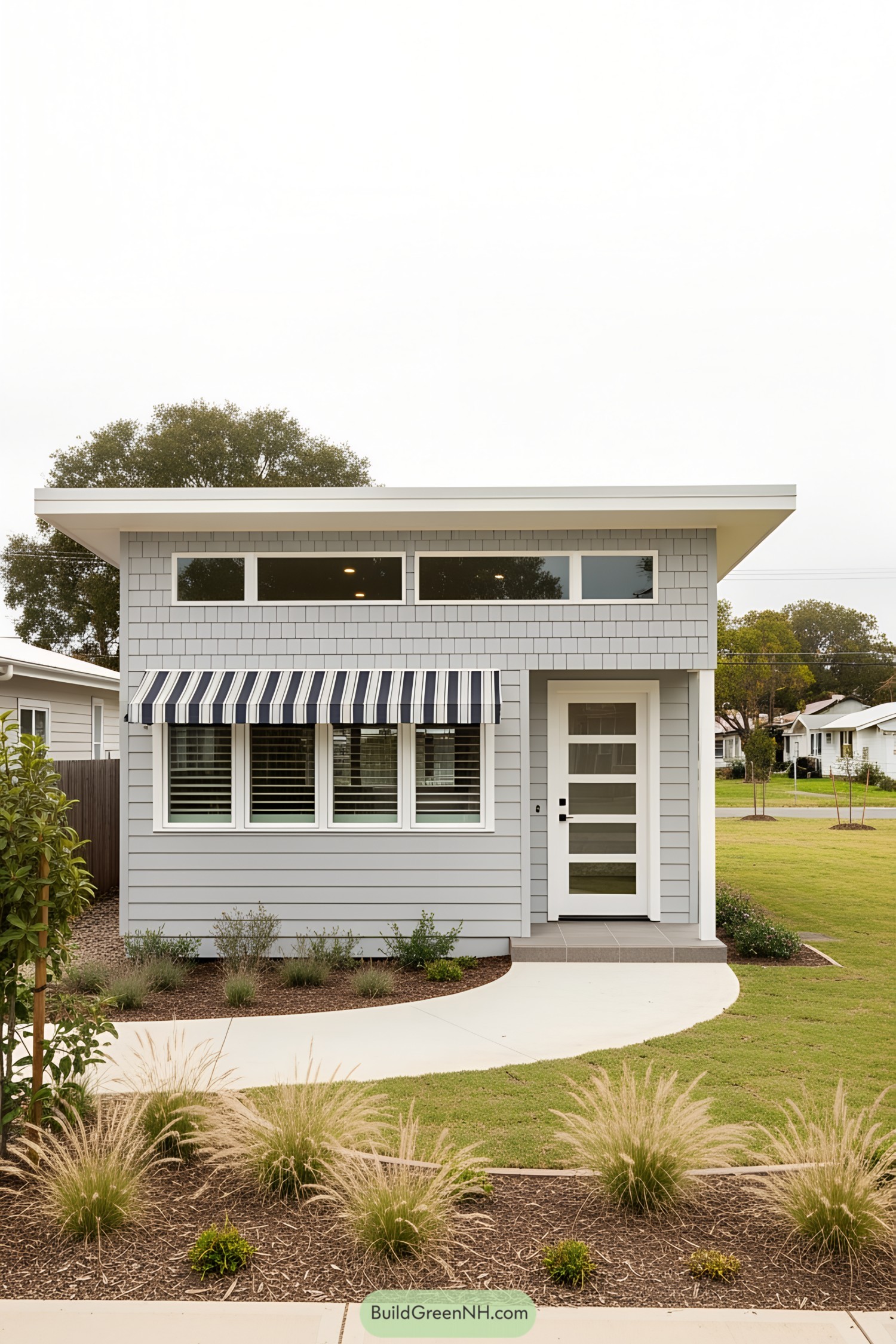 Coastal bungalow with striped awning and sleek design