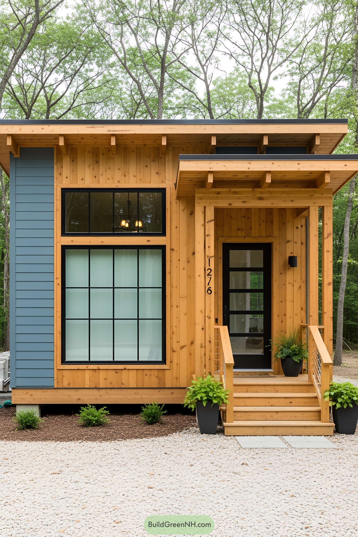 Small wooden bungalow with large windows and front porch