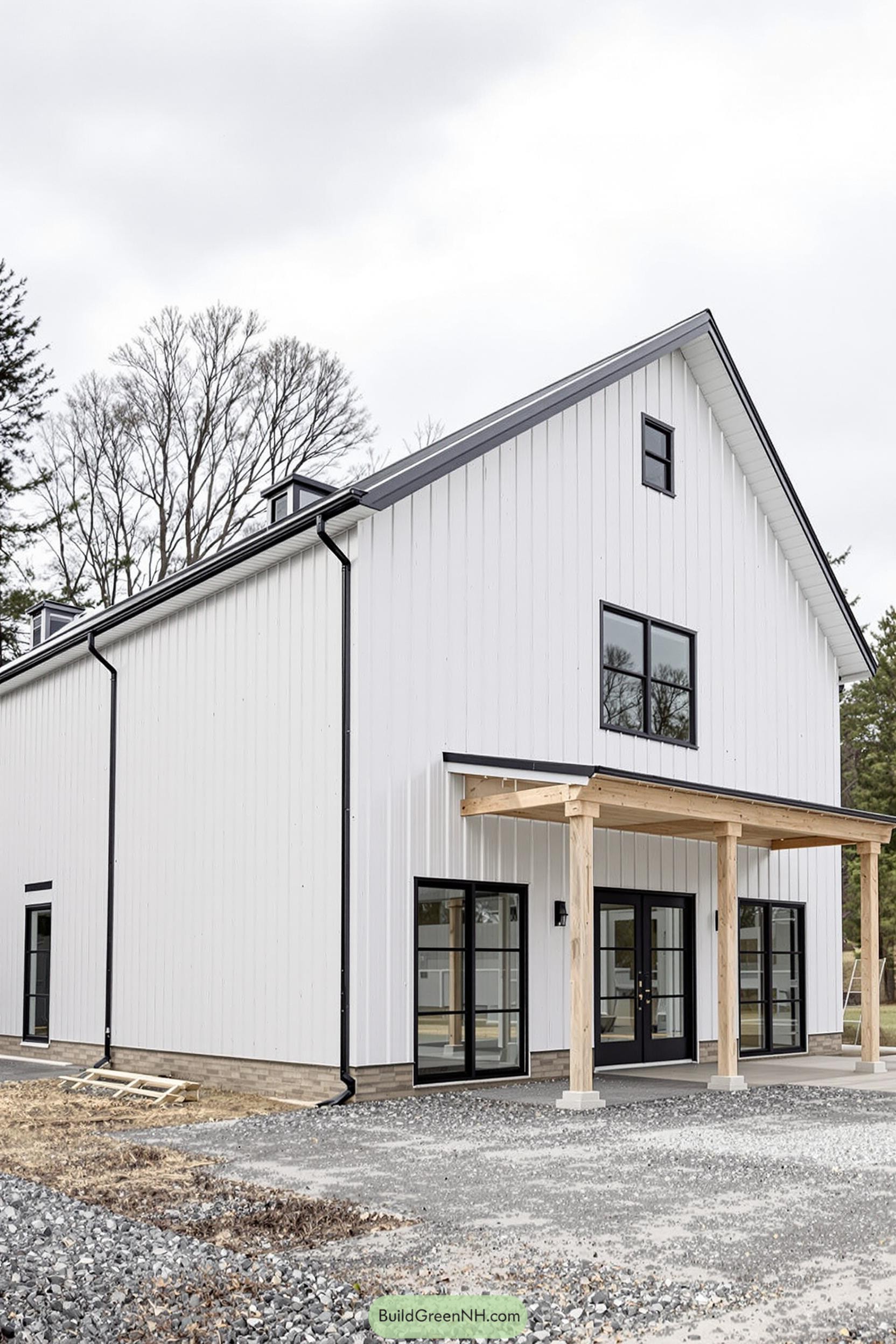 A modern white barndominium with wood accents