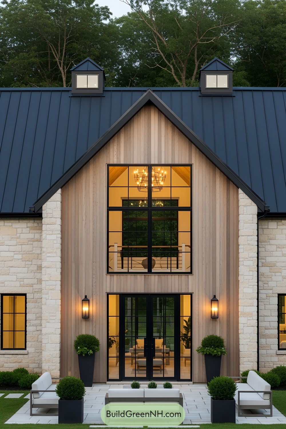 Barndominium exterior with large windows and a peaked roof