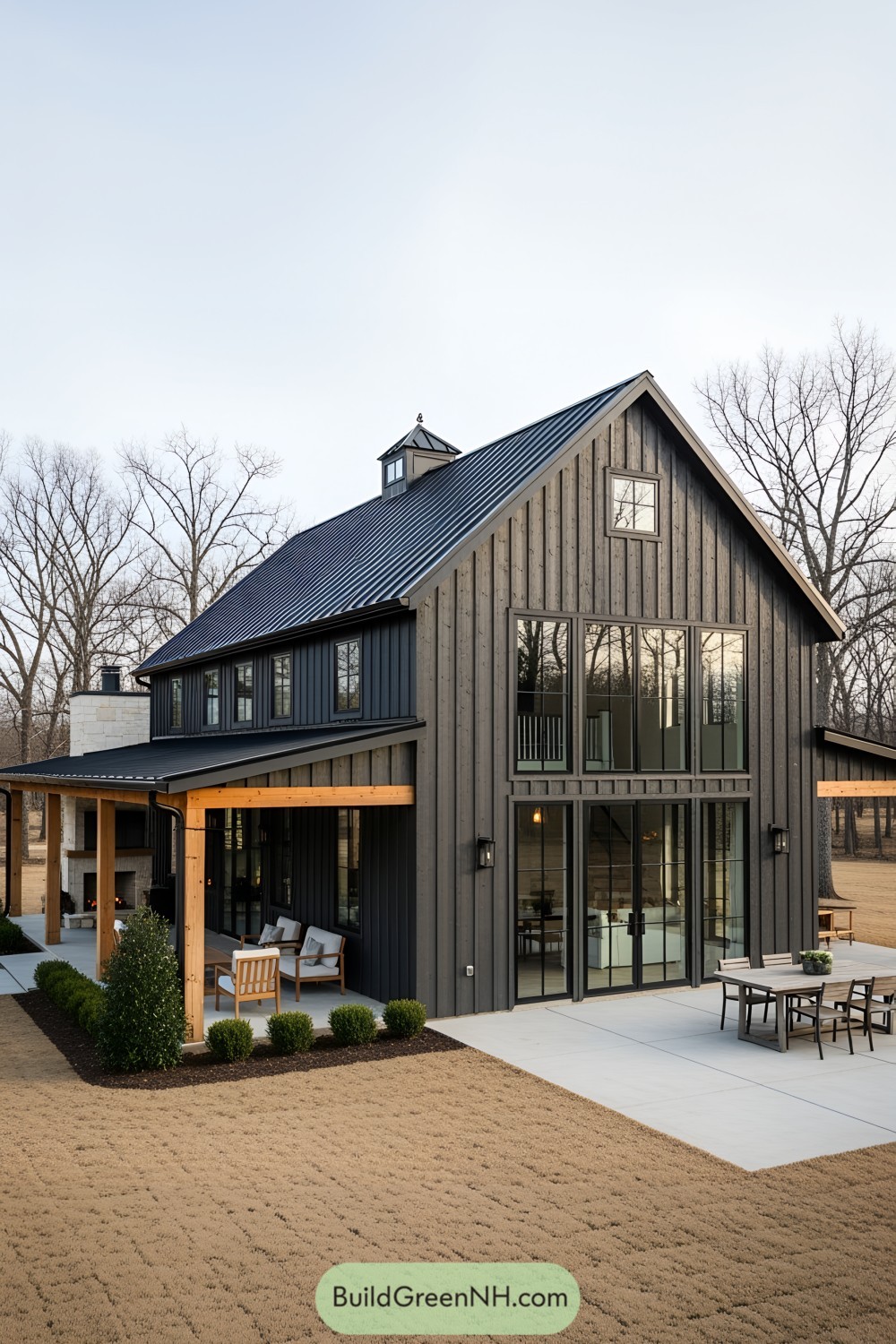 Modern farmhouse exterior with large glass doors and a sleek roof