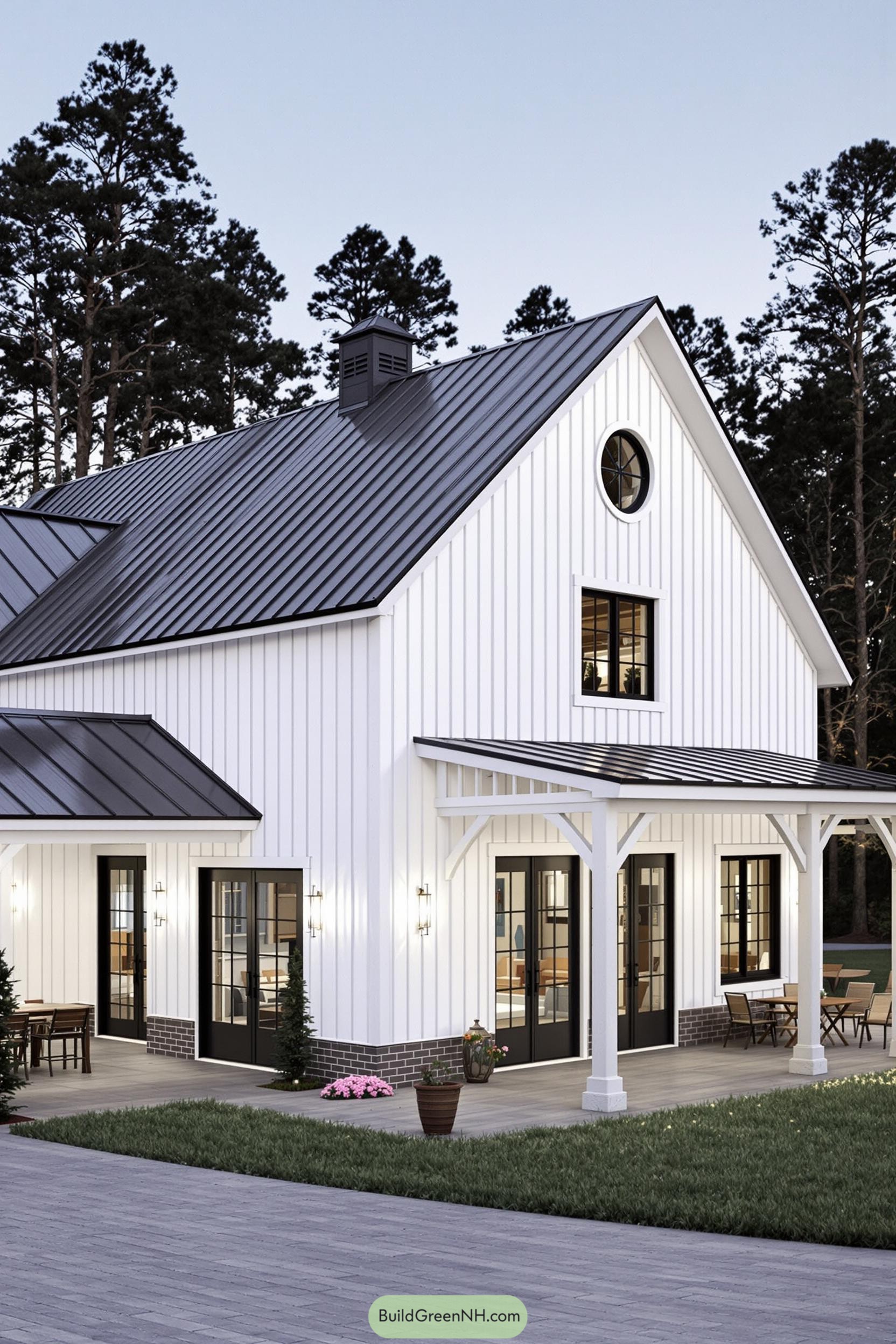White barndominium with black roof and cozy porch
