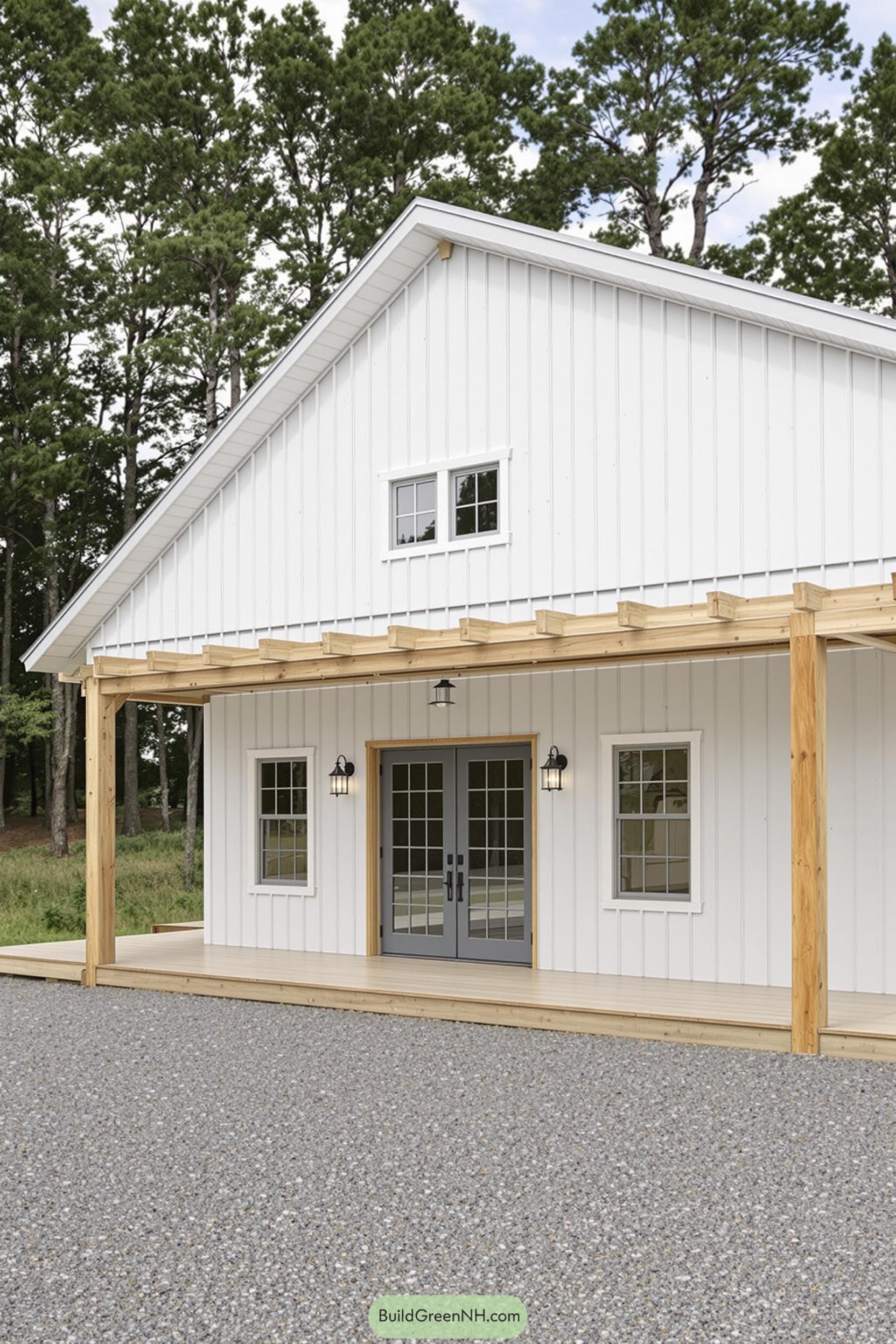 White pole barn house with porch and double door