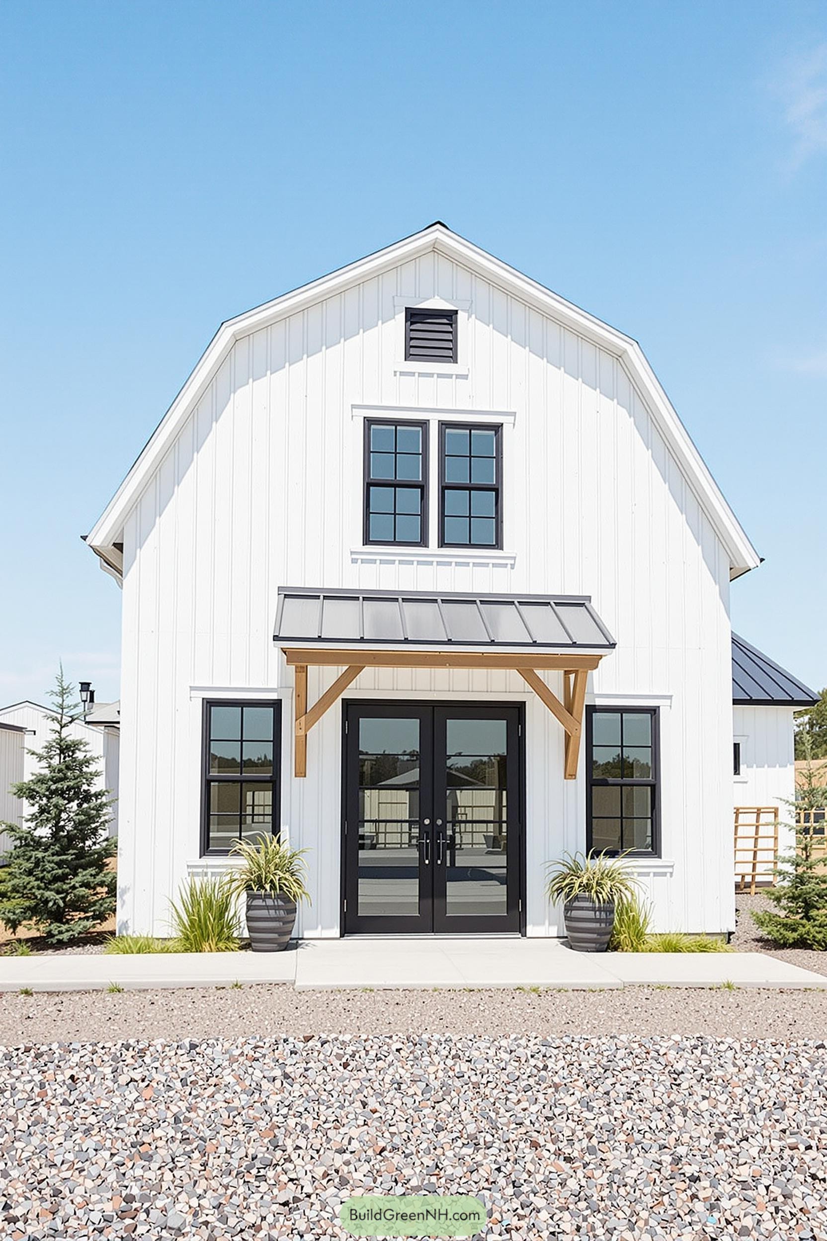 White barndominium with black accents