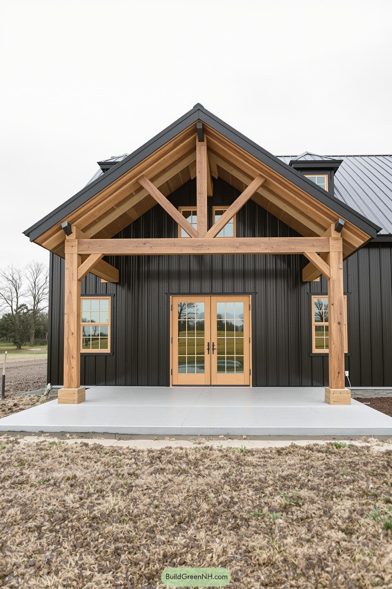 Modern black barnhouse with wooden accents and large front porch