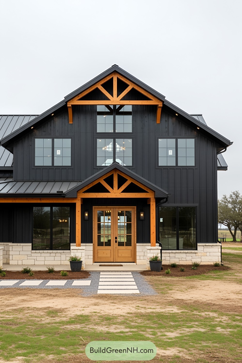 Black barndominium with wooden accents and large windows