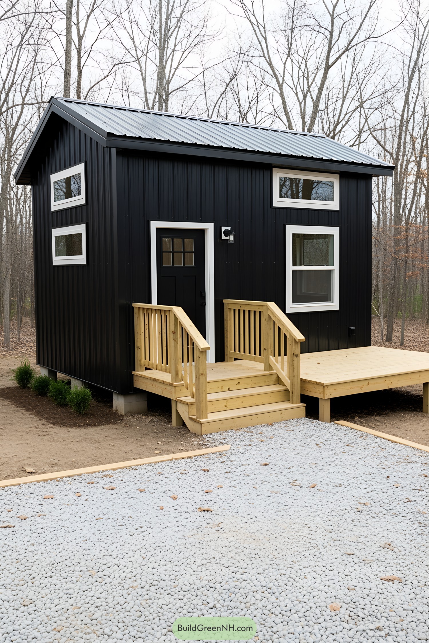 Modern tiny house with a black exterior and wooden porch