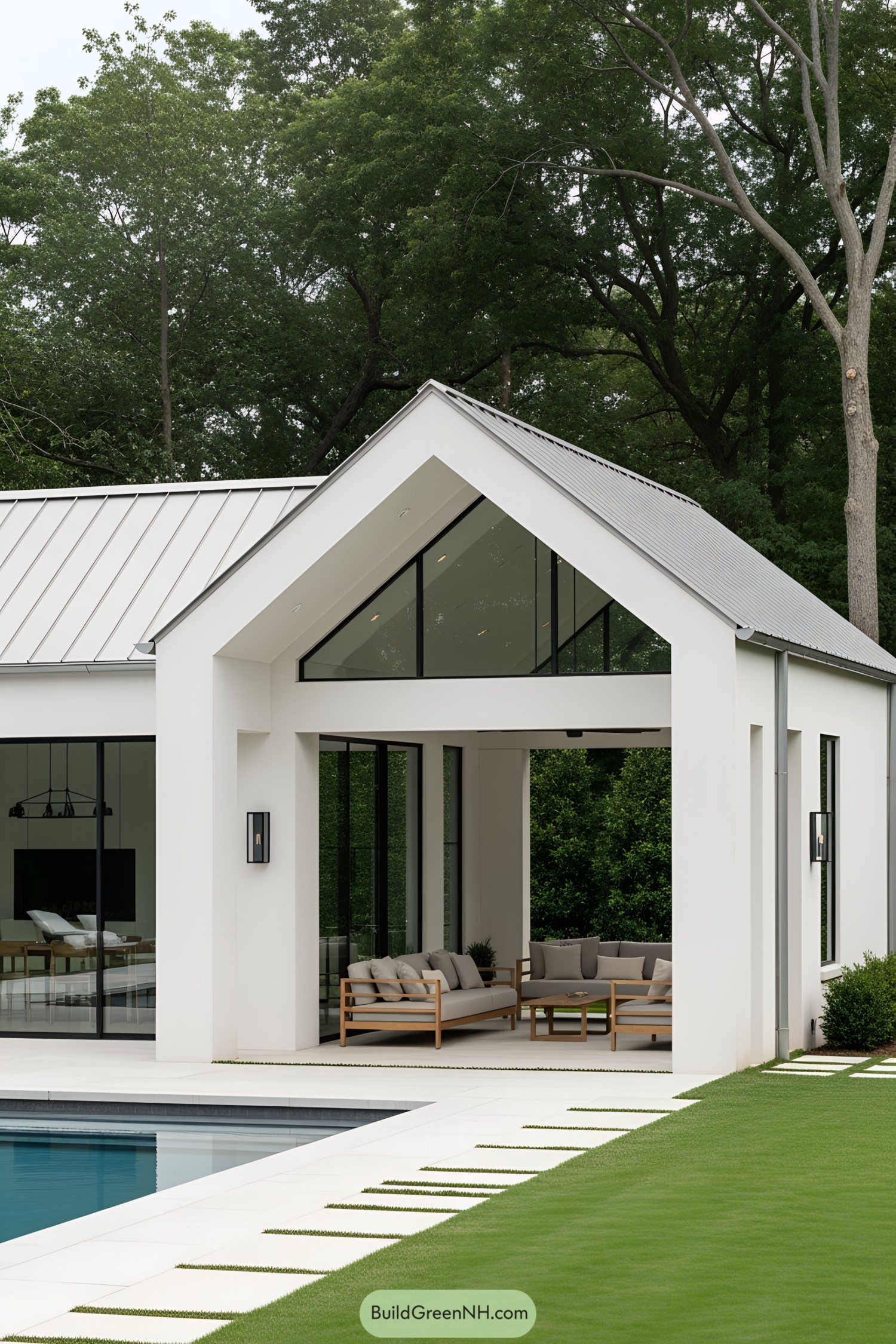 Modern pool house with glass walls and lush greenery