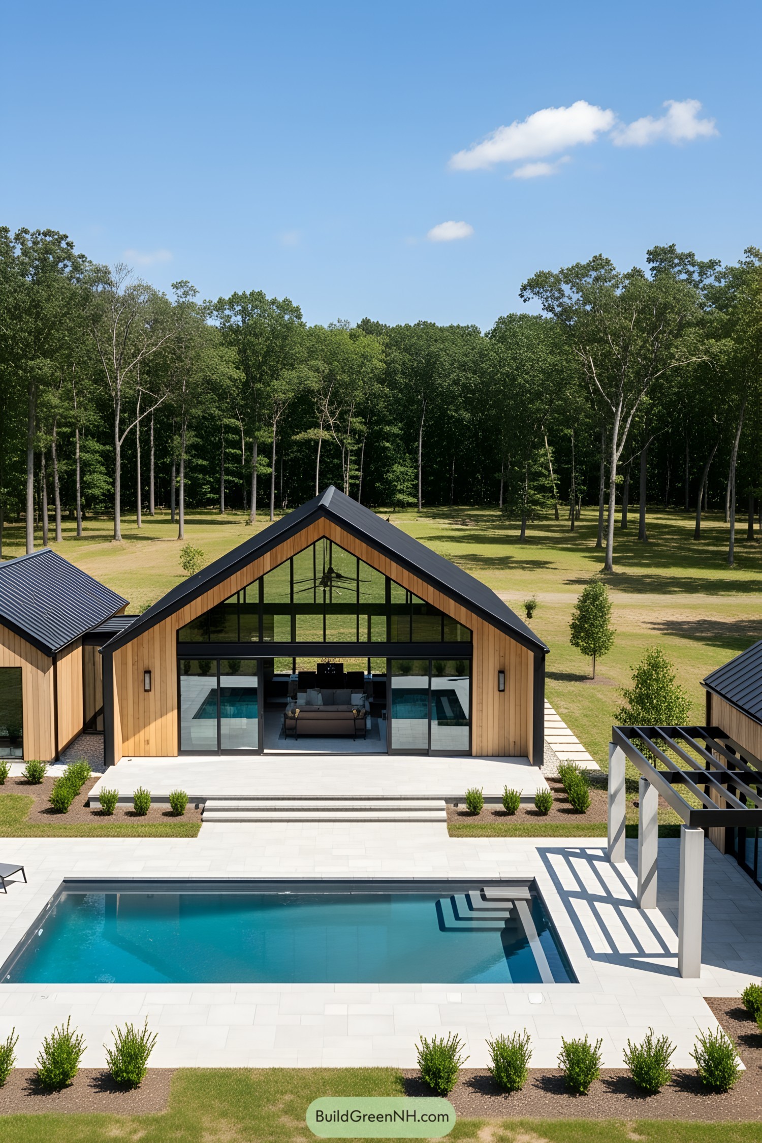 Contemporary barn-style pool house with patio and pool