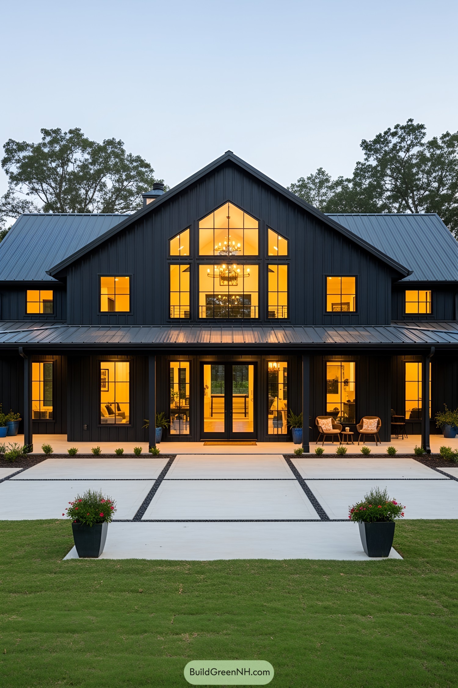 Black barn house with illuminated windows and a modern facade