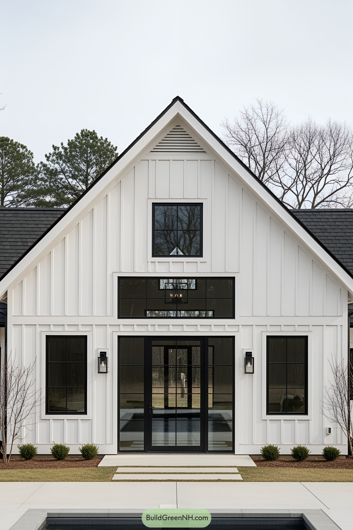 White barn-style house with large windows and a sleek design