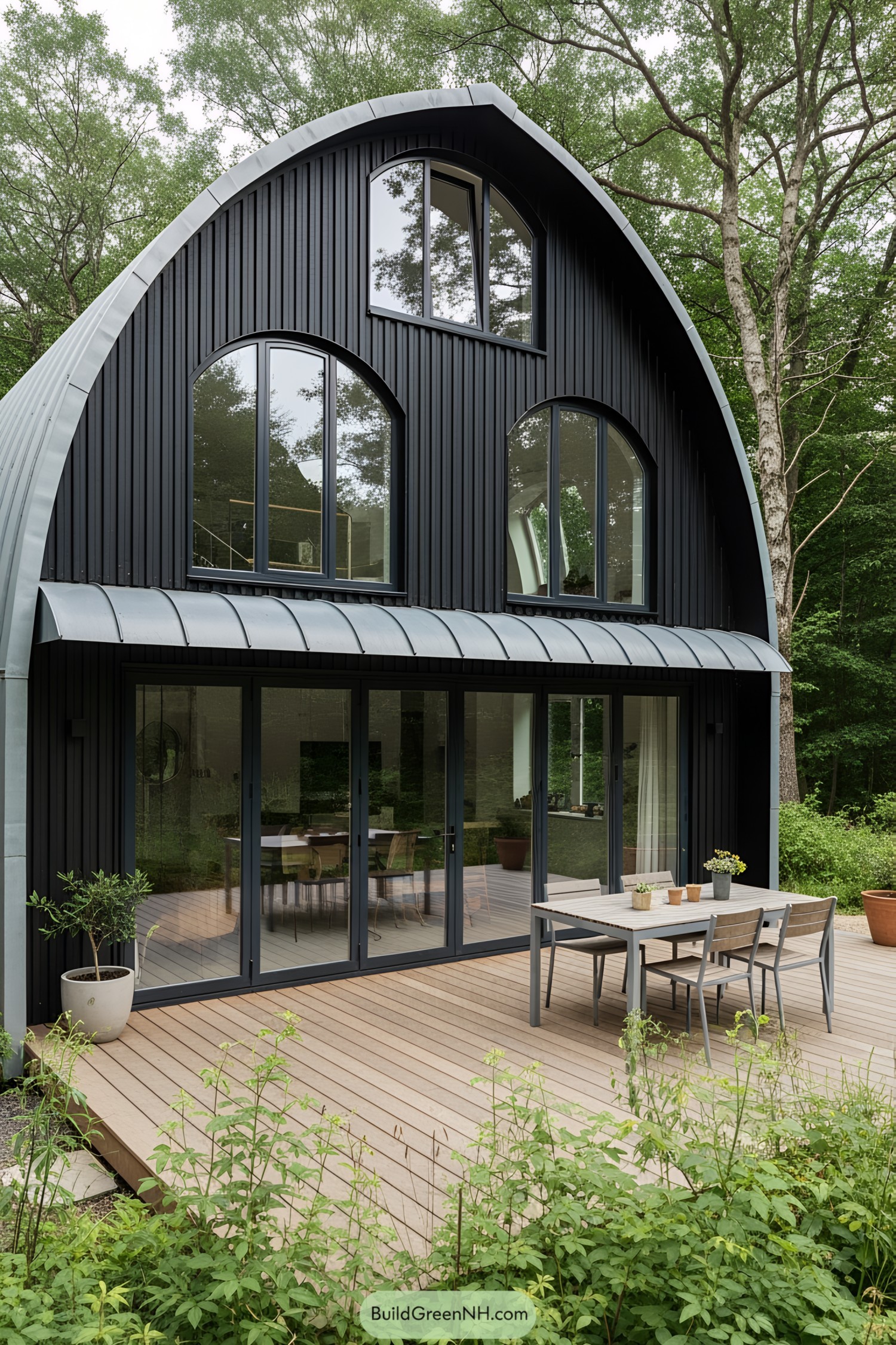 Modern black house with large windows and a curved roof