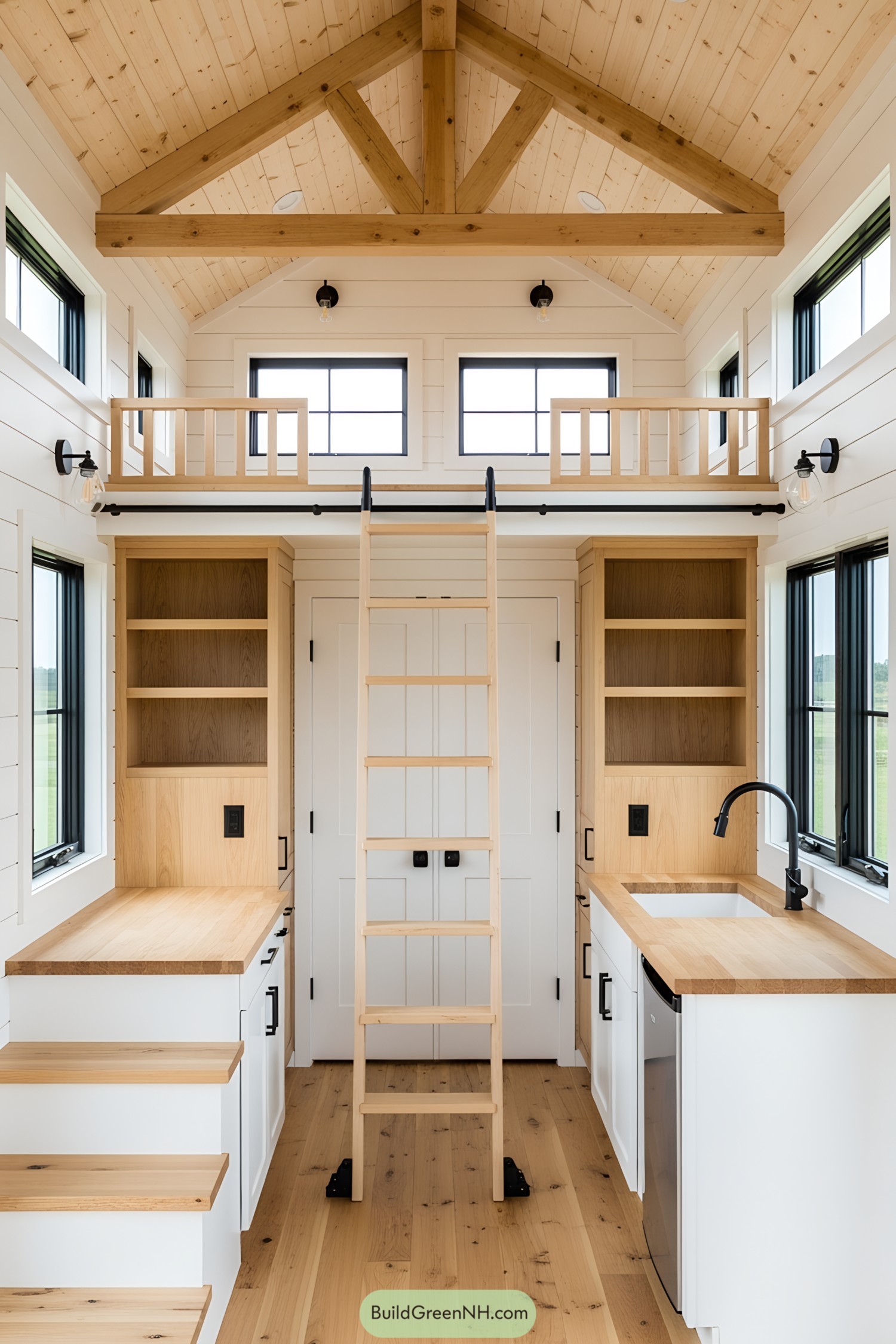 Interior view of a lofted barn tiny house with wooden finishes and a ladder