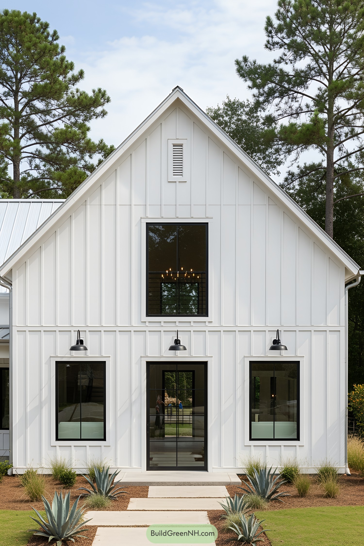 White barn style house with tall, narrow windows