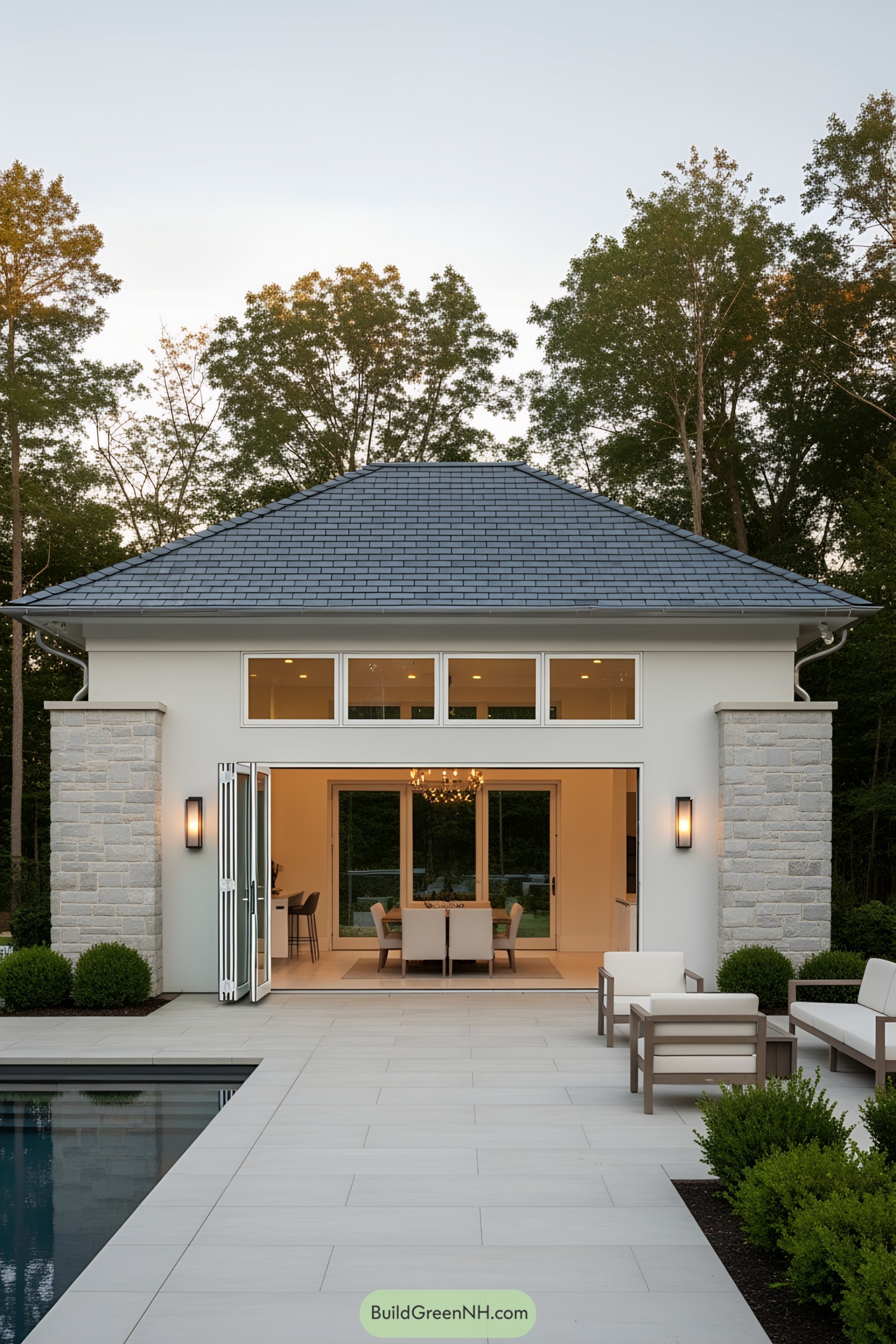 Modern pool house with open doors and seating area