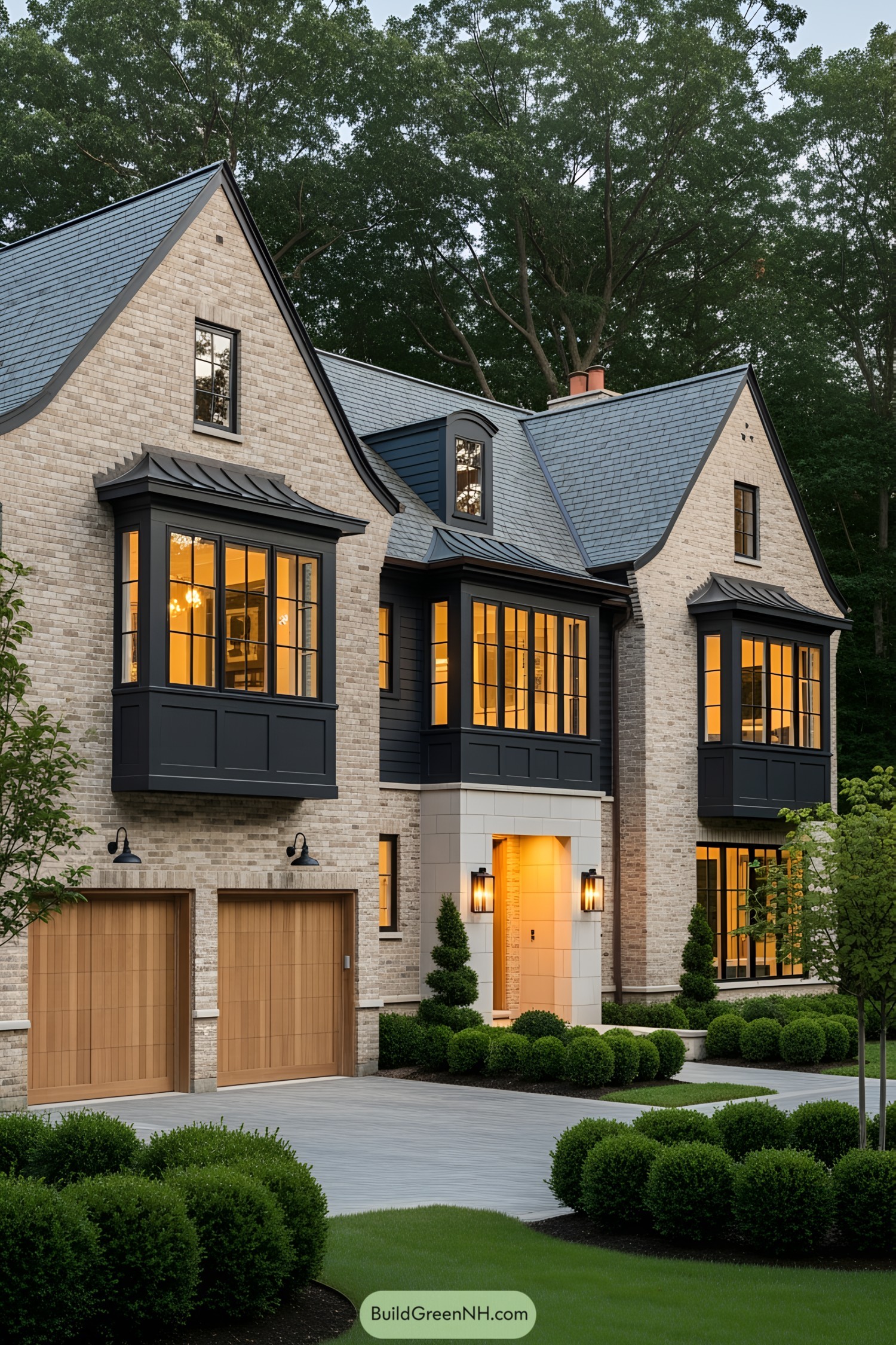 Elegant brick house with gabled roofs and large glowing windows