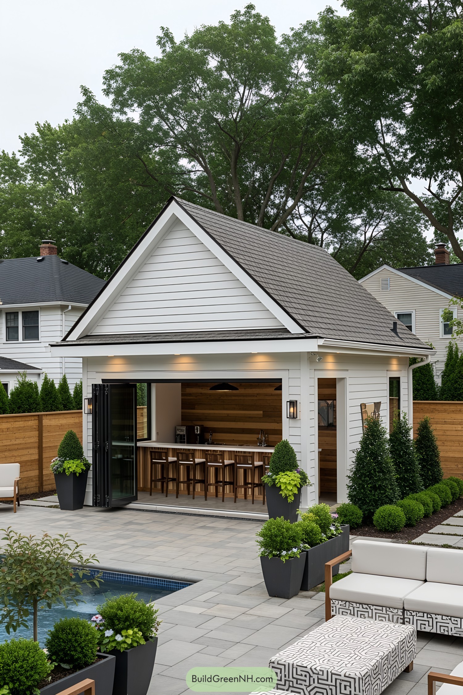 Chic modern pool house with bar seating and lush greenery