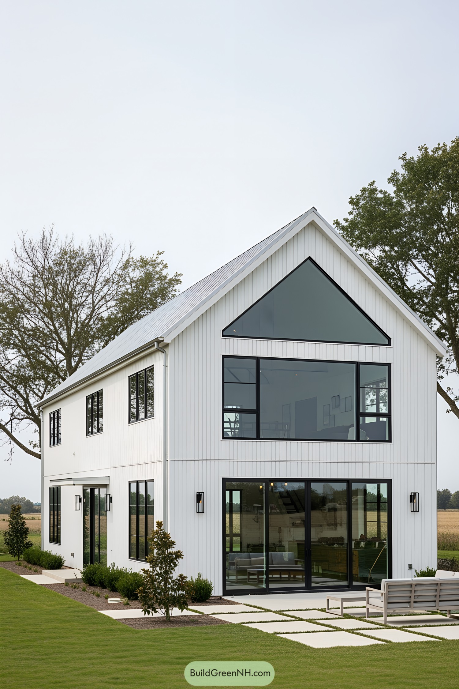Modern white barn house with large windows and sleek design