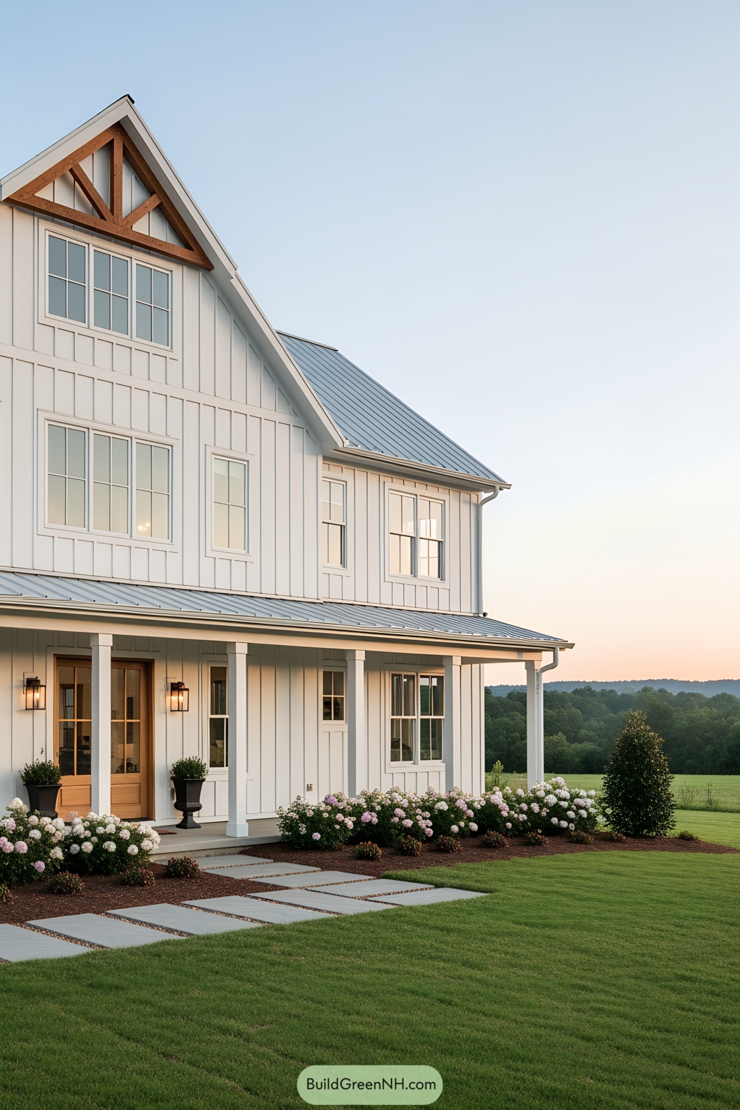 A picturesque white barn house at sunset with lush greenery