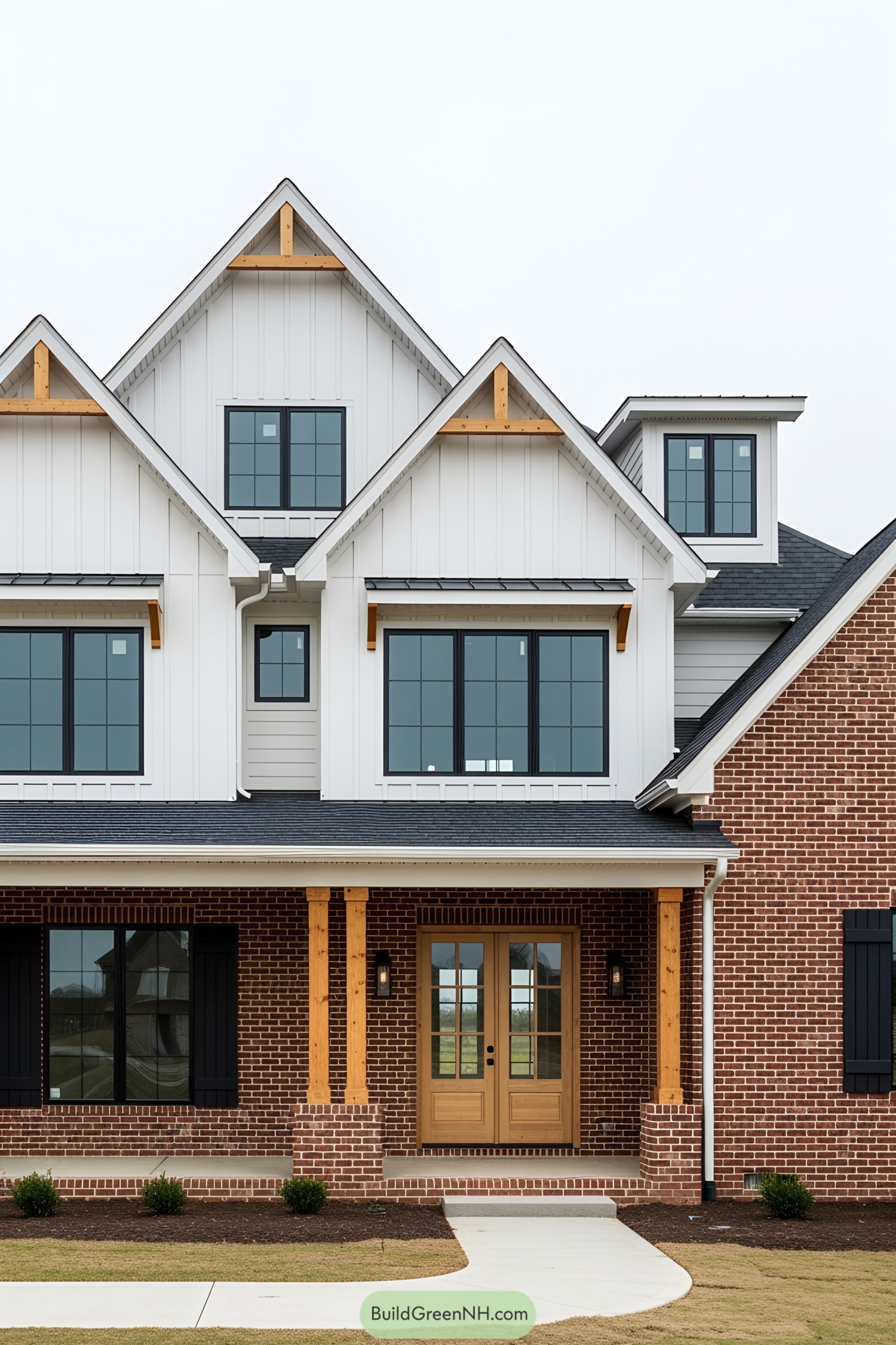 Two-story brick house with white gables and large windows