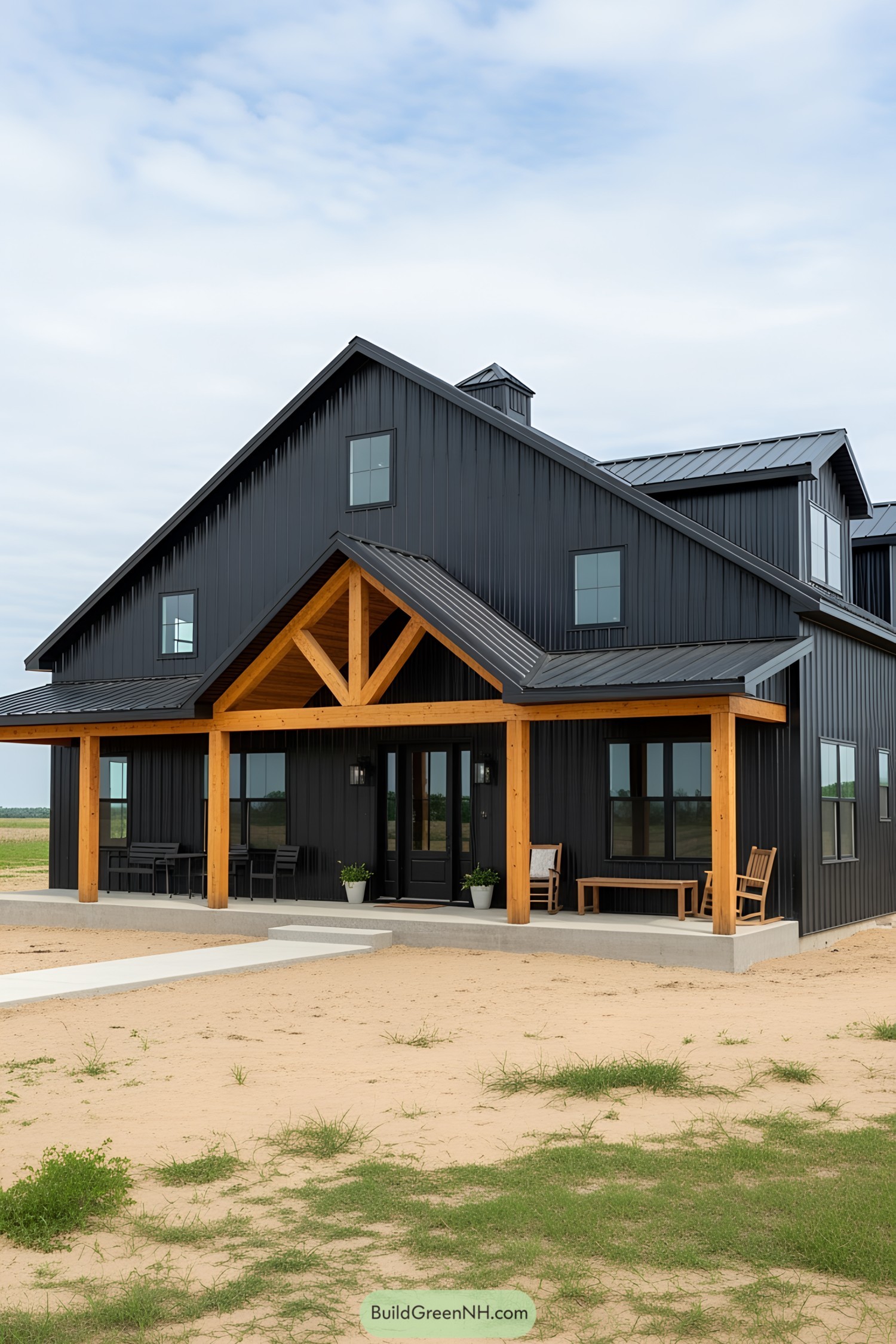 Black barn house with wood accents and clear sky