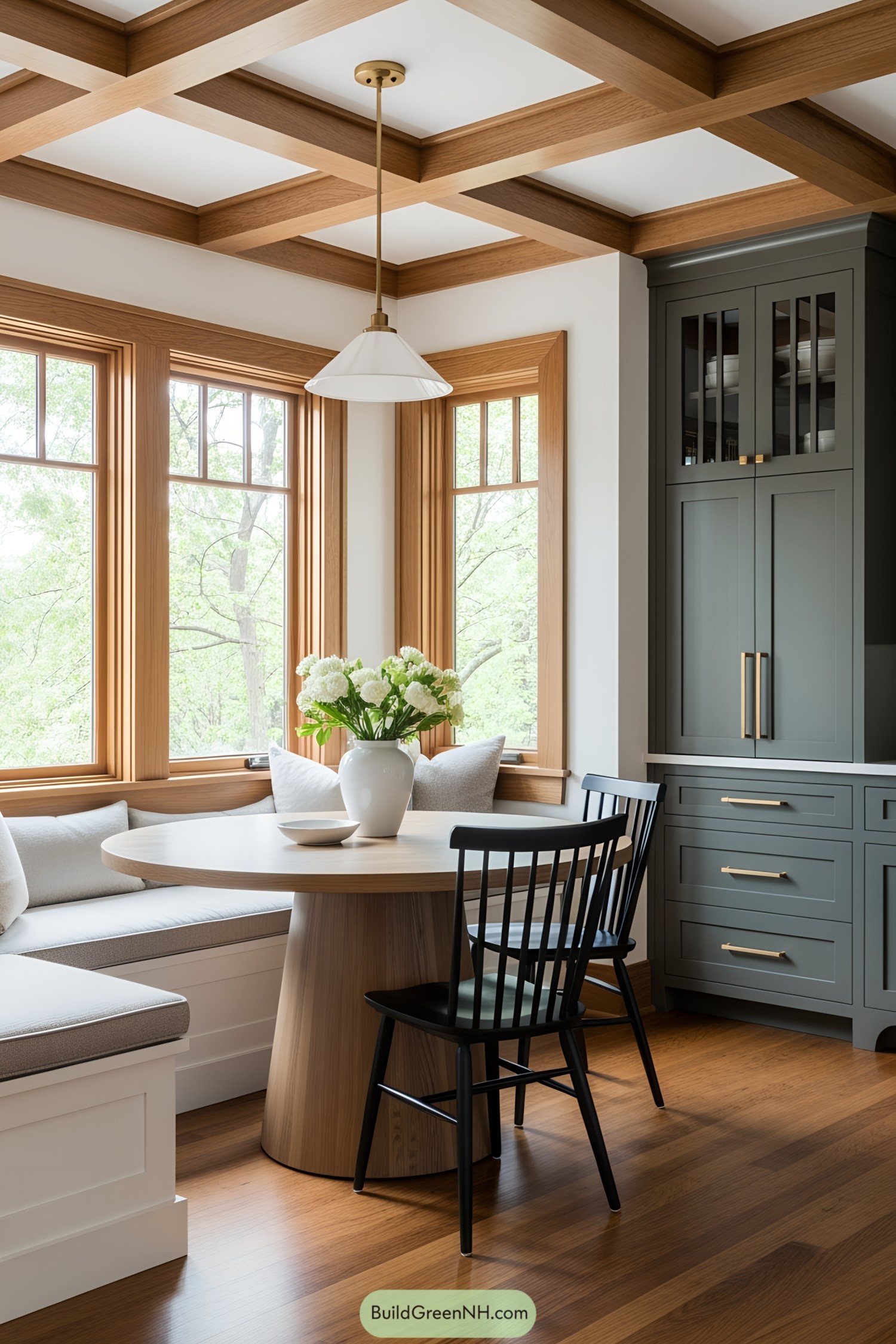 A cozy breakfast nook with wooden accents and a vase of flowers