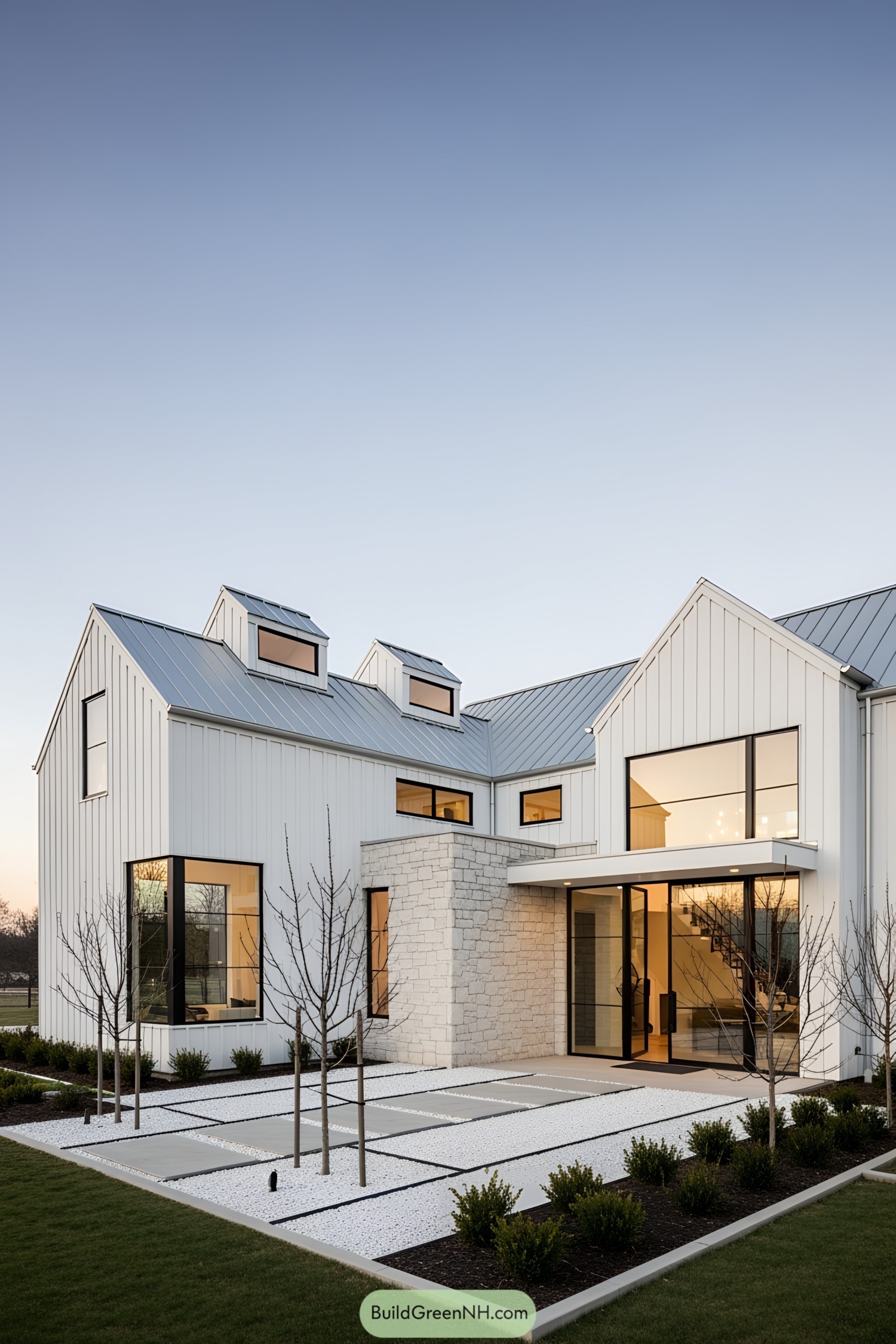 White barn house with large windows and a stone accent wall