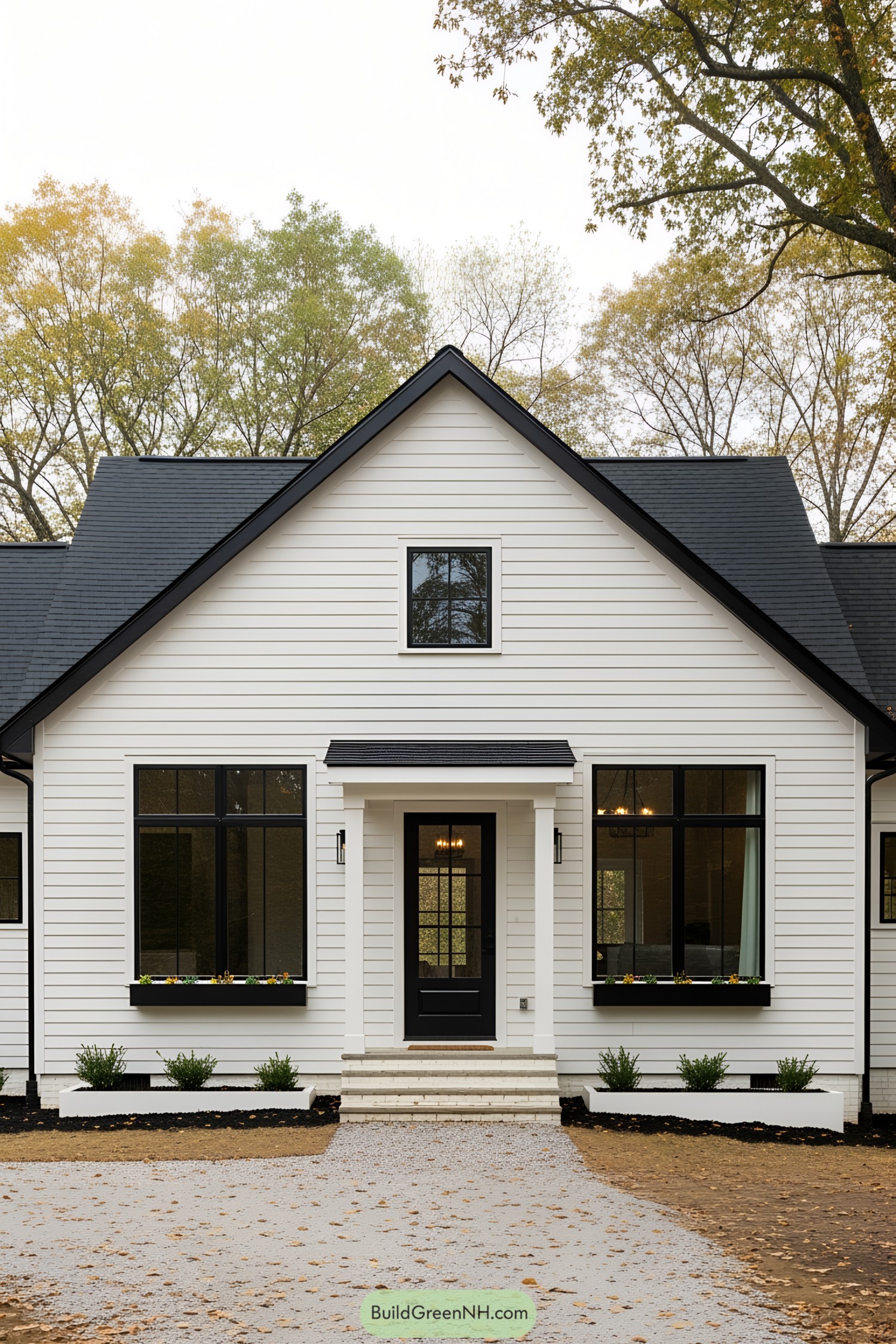 Chic white bungalow with black accents surrounded by trees