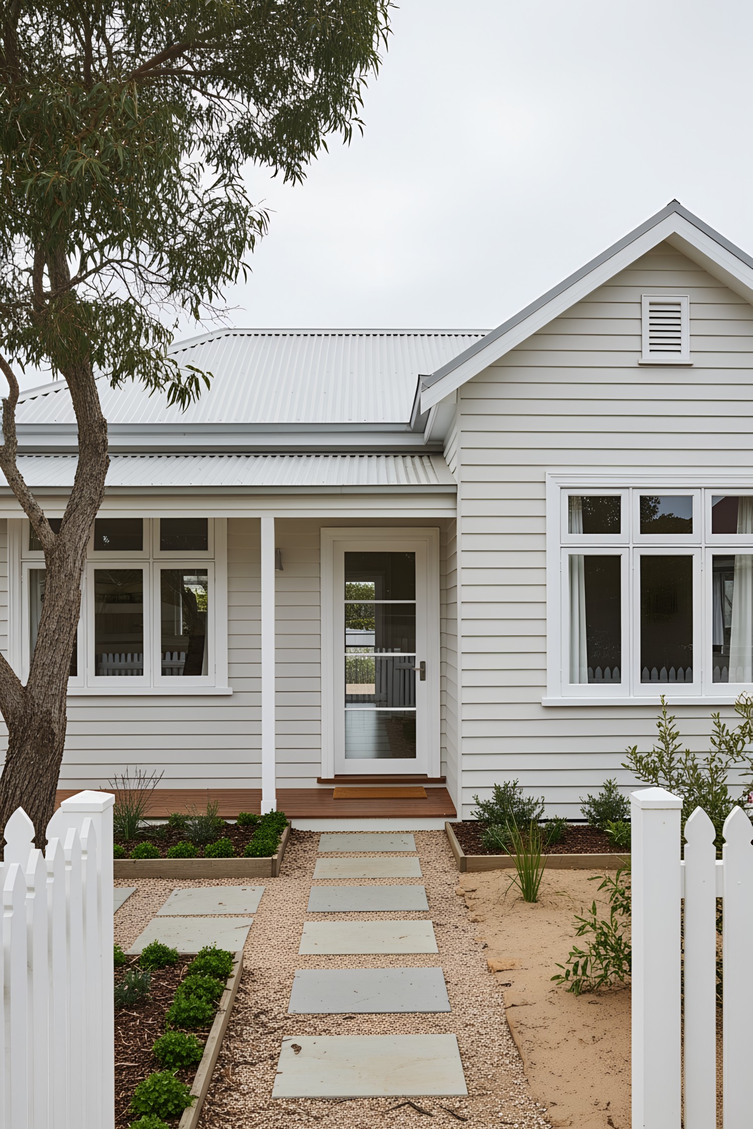 White coastal house with a welcoming garden pathway