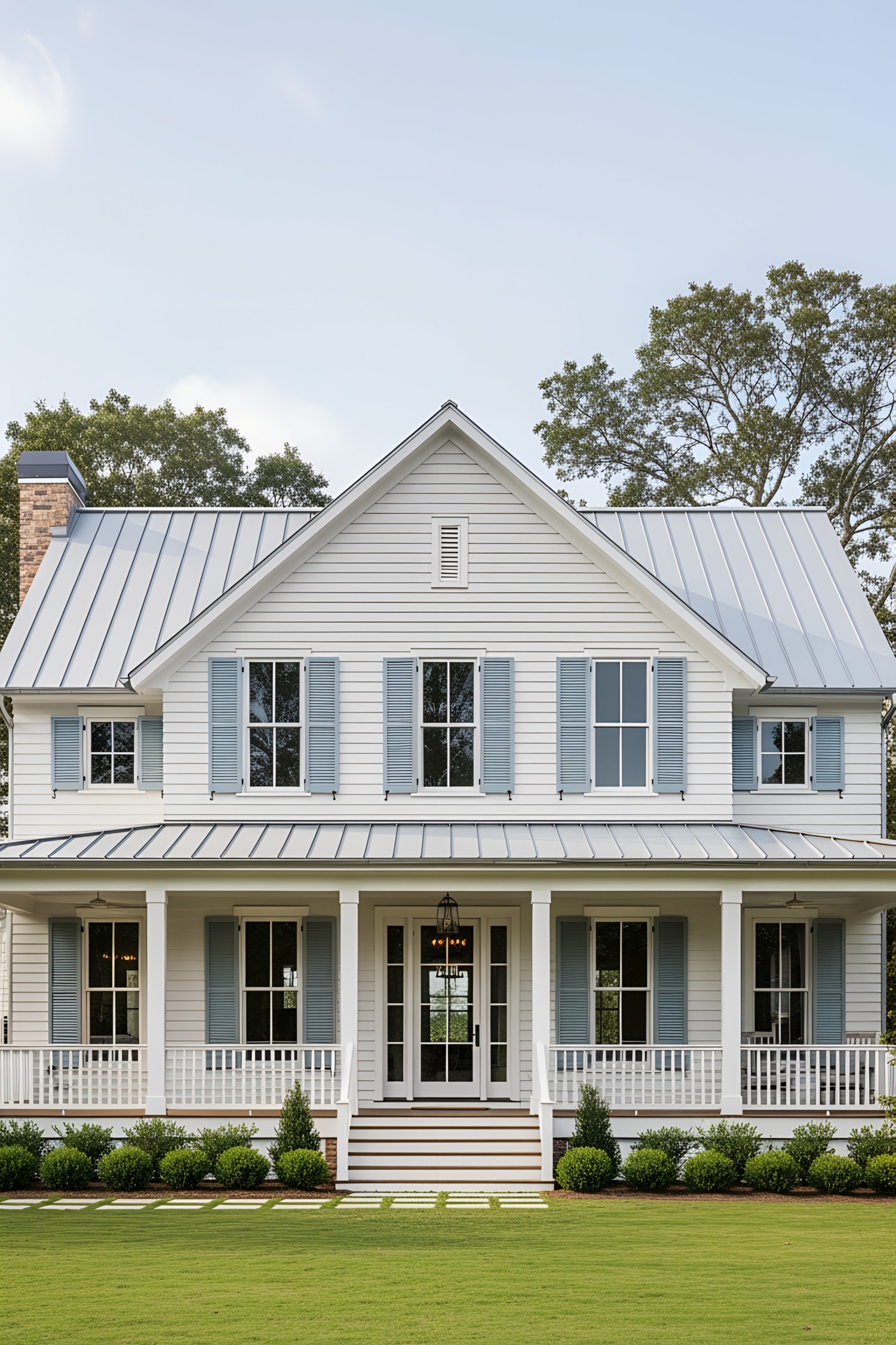 Charming coastal house with blue shutters and wide porch