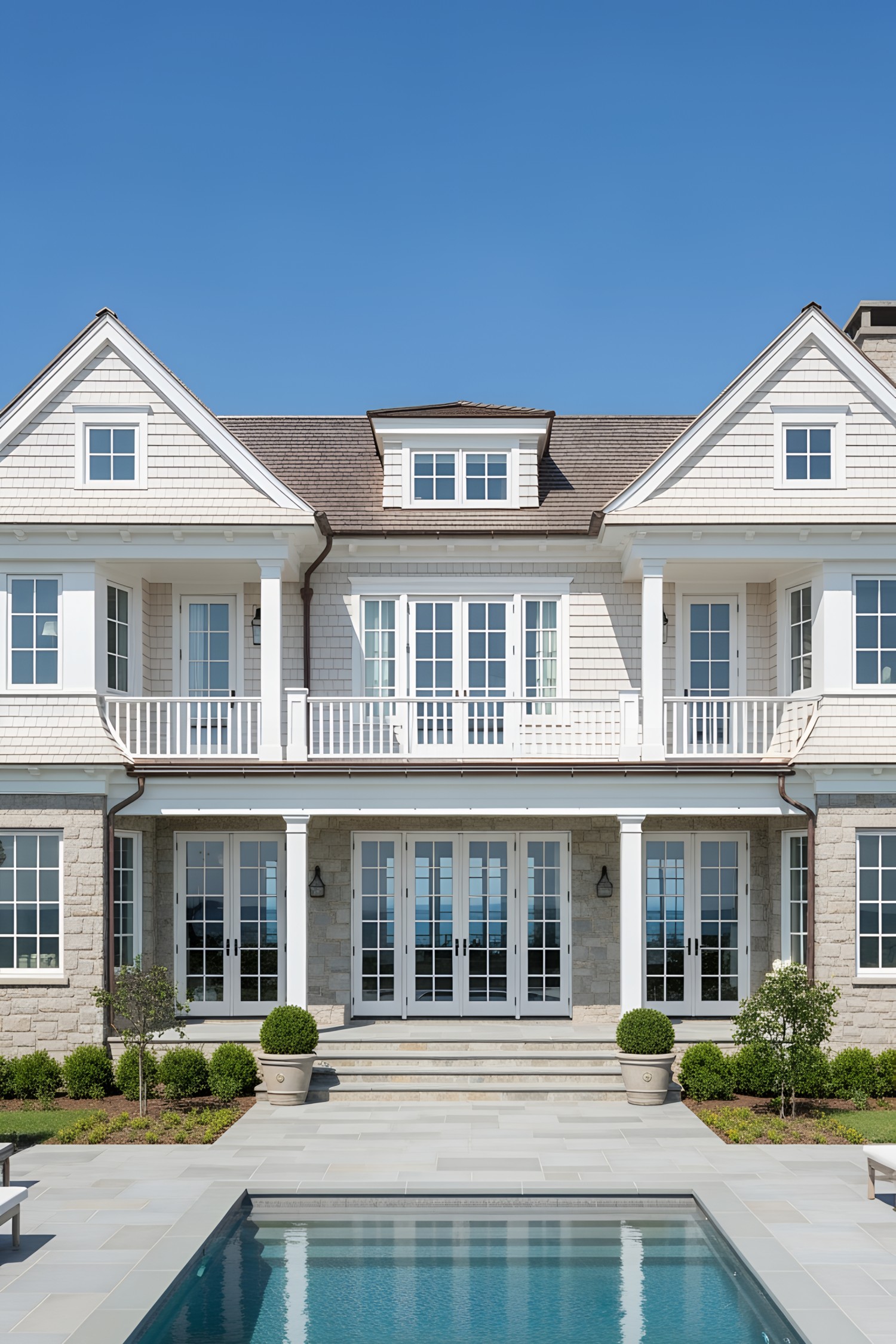 Coastal house with white siding and pool