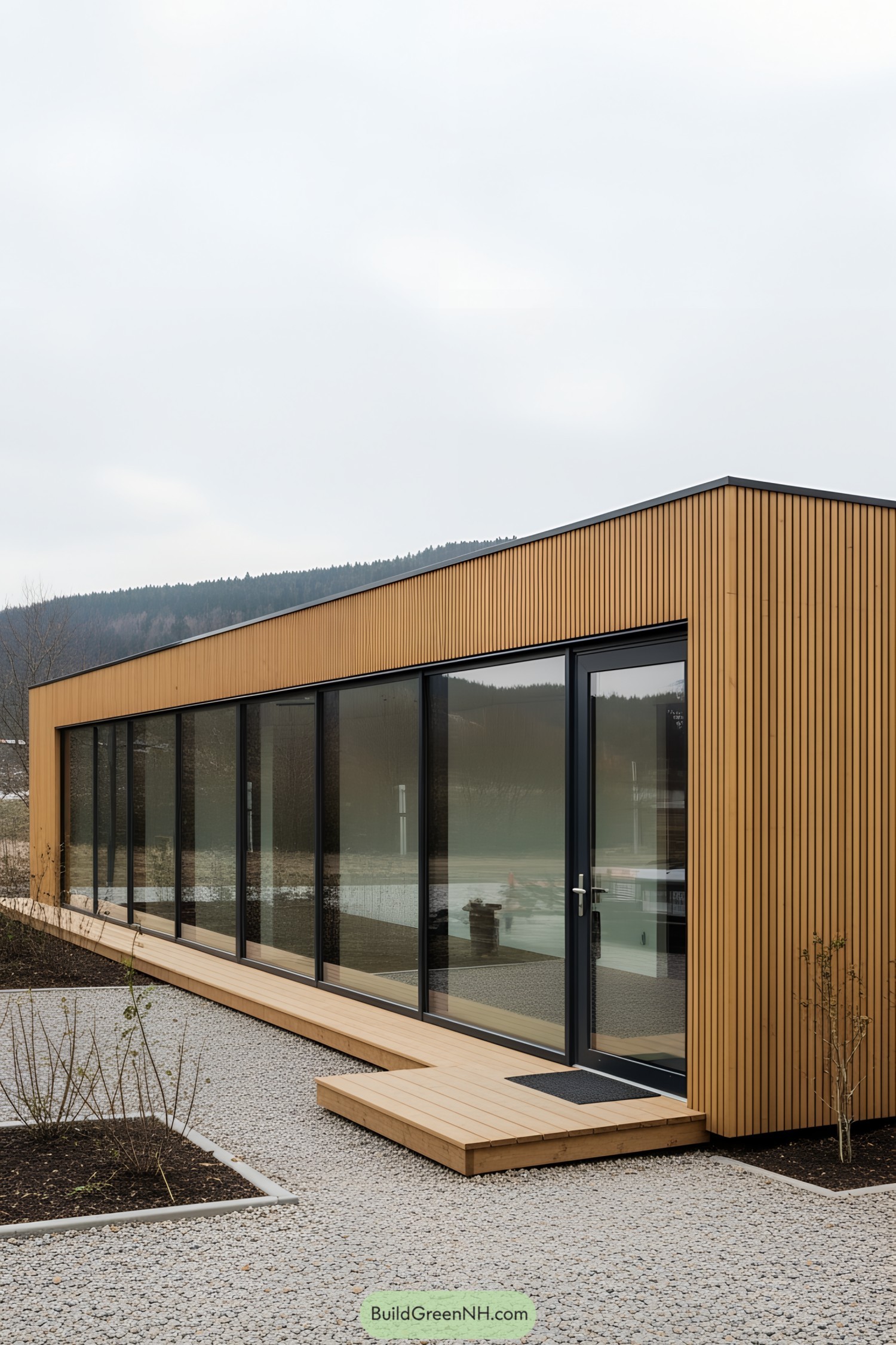 Container office with large windows and wooden exterior