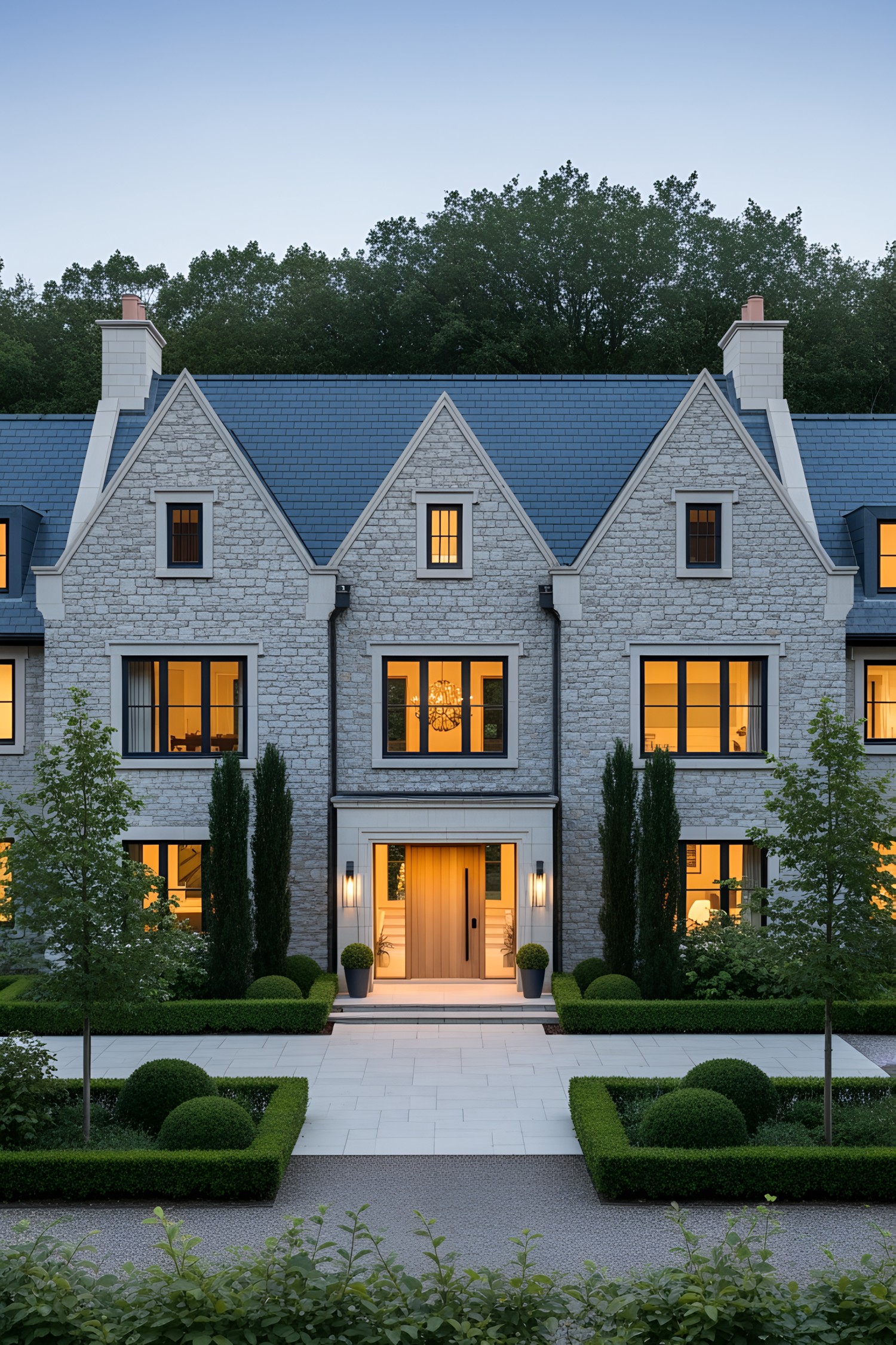 Contemporary country manor house with a stone façade and landscaped garden