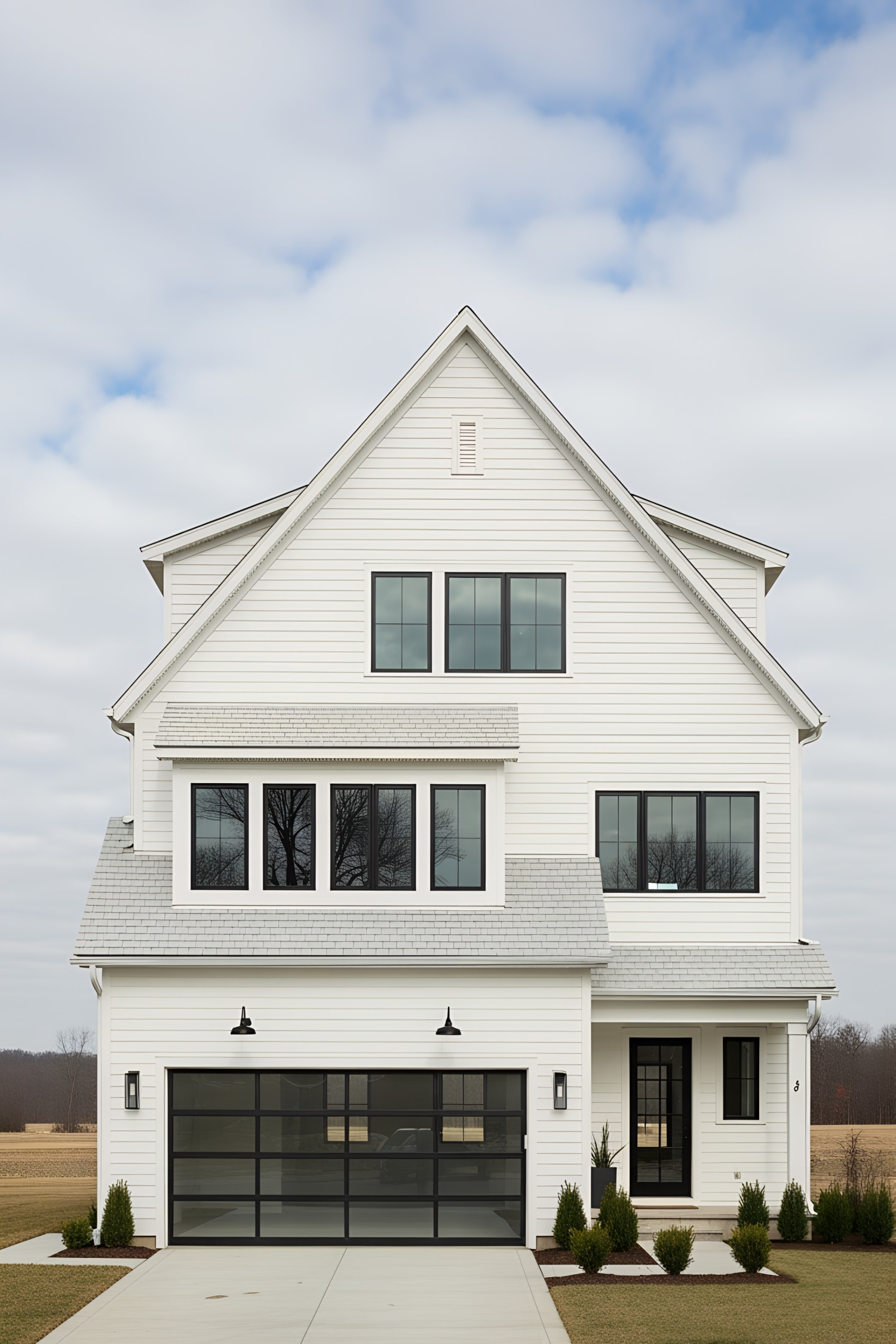 Farmhouse with large windows and glass garage door
