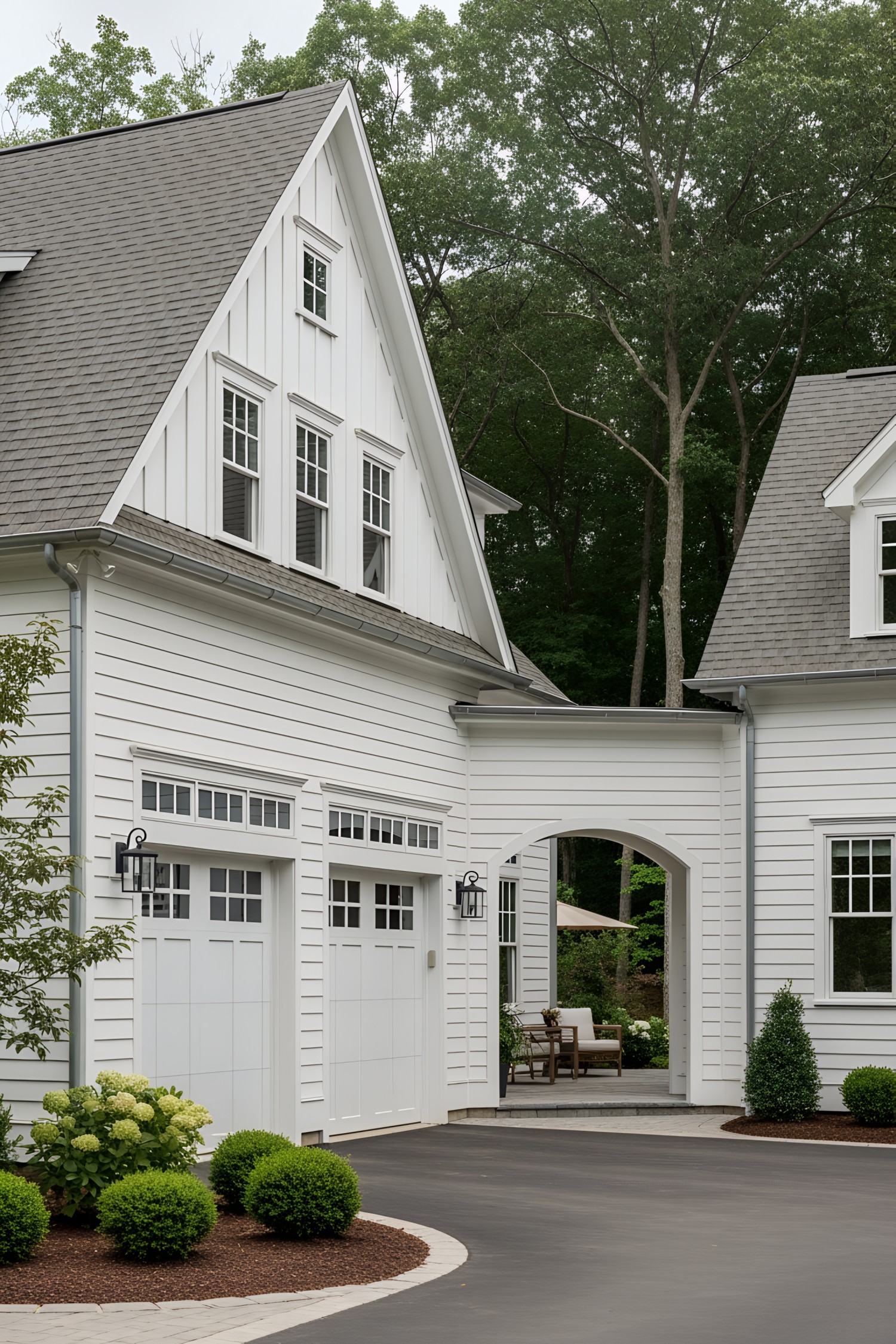 White farmhouse with gray roof and attached garage