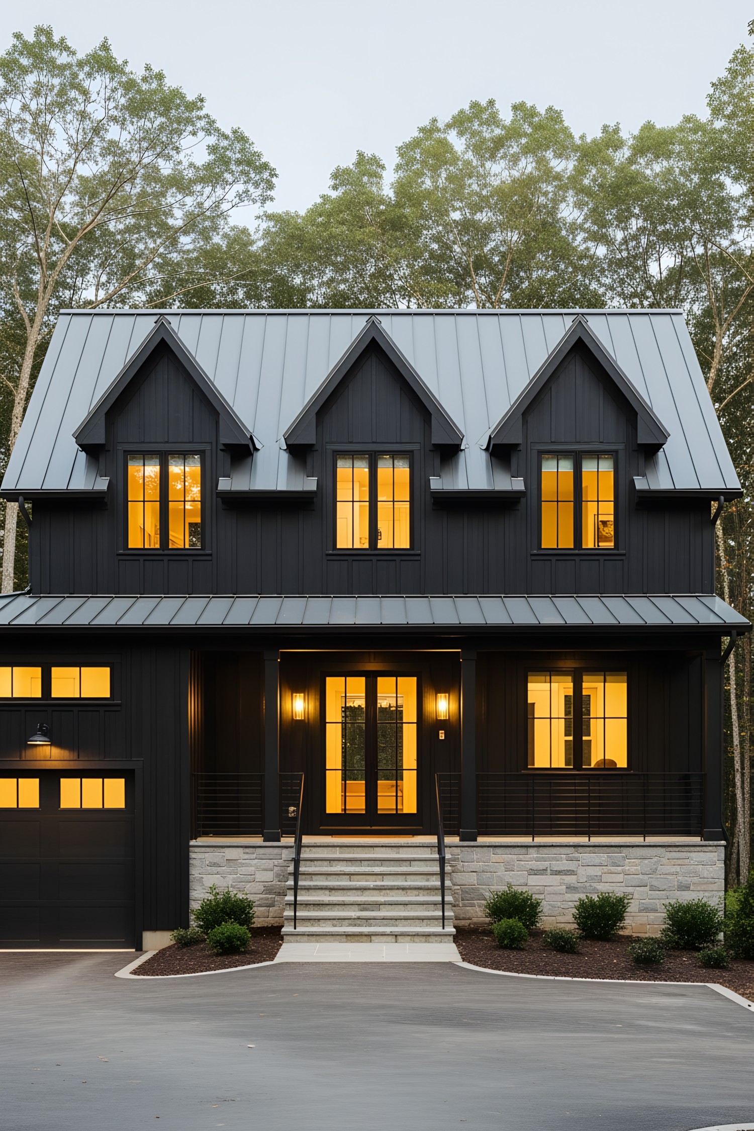 Charming black farmhouse with warm yellow-lit windows