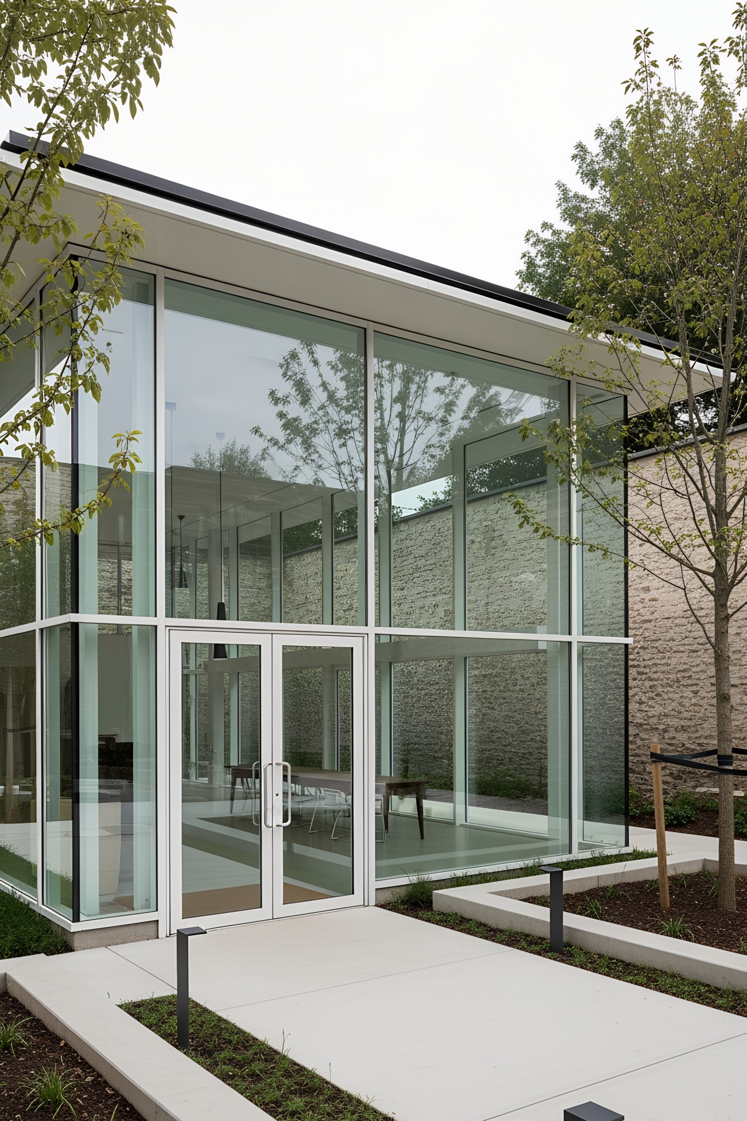 Modern glass pavilion with greenery