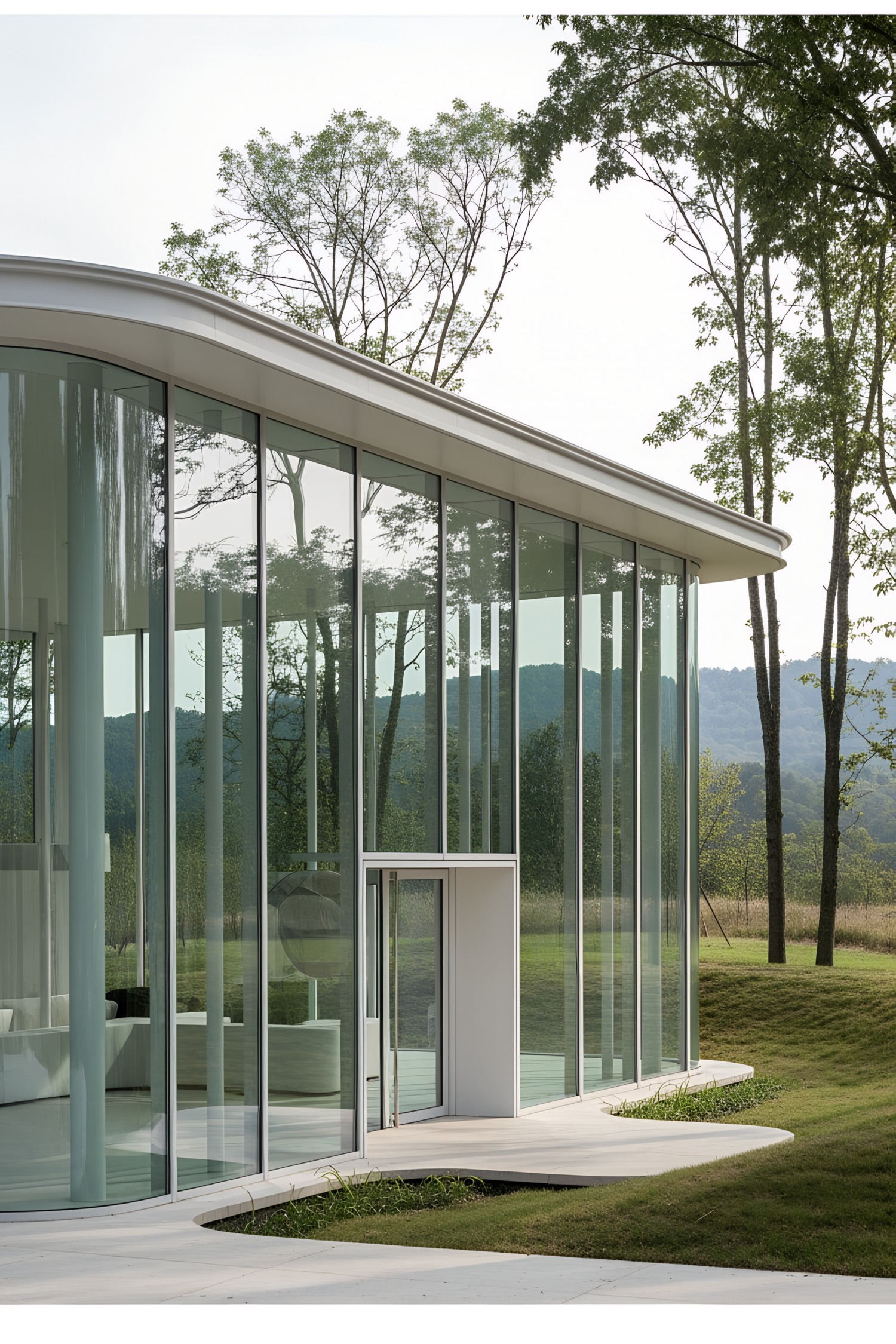 Modern pavilion with large glass windows in a natural setting