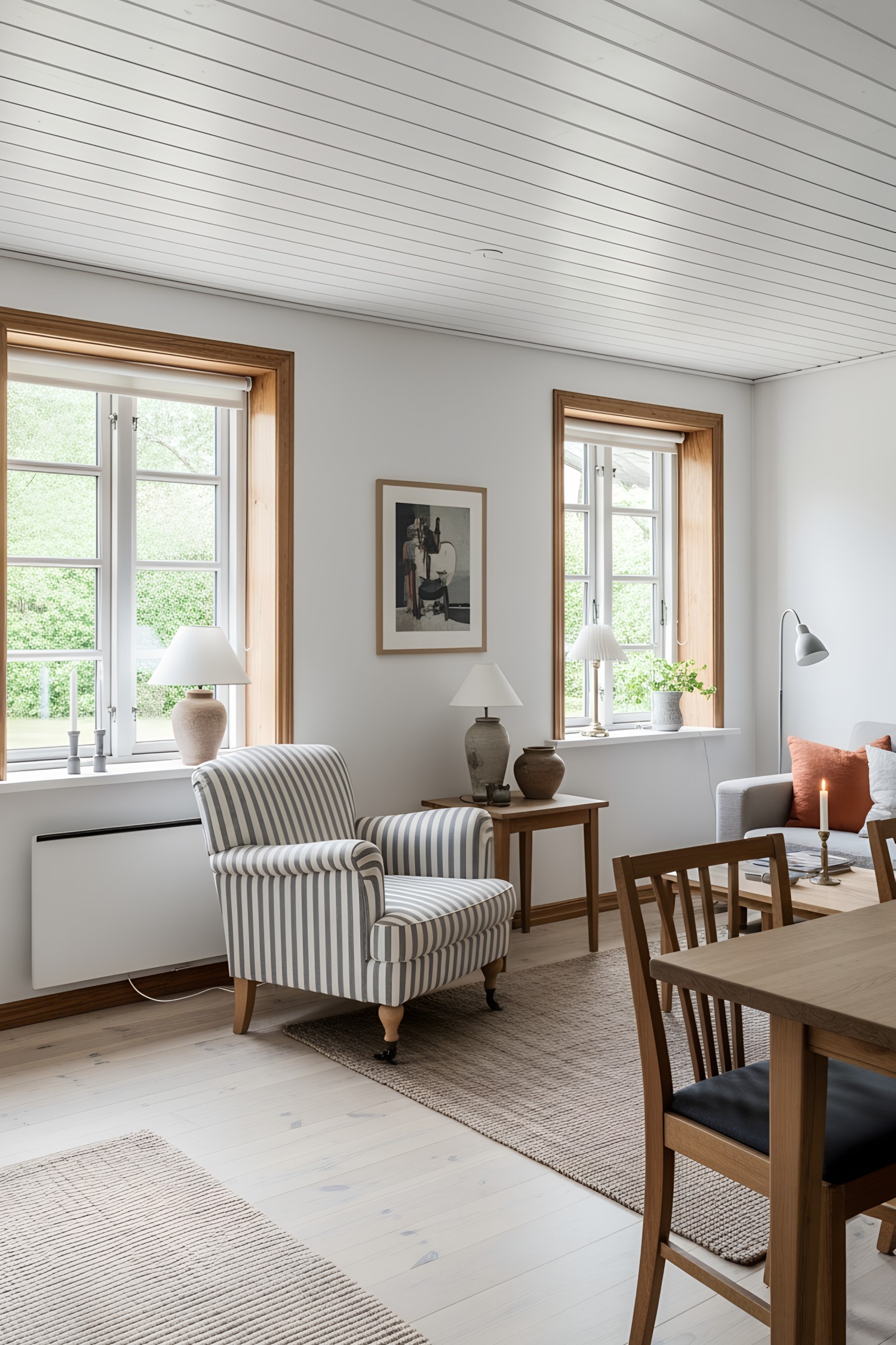 Cozy chair next to wooden windows in a Swedish cottage