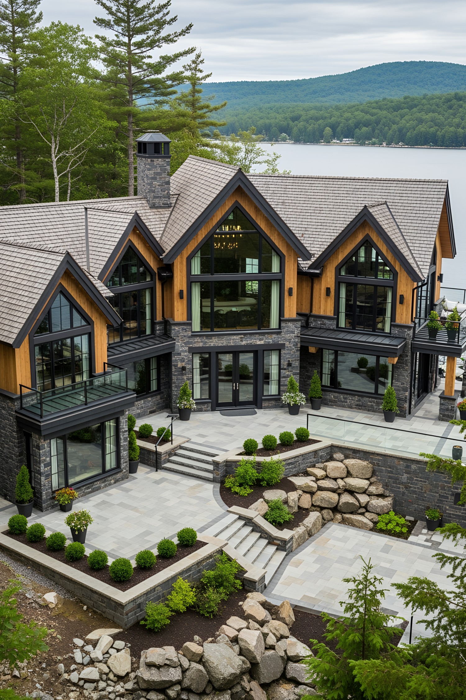 Luxurious lakeside house with large windows and stone facade
