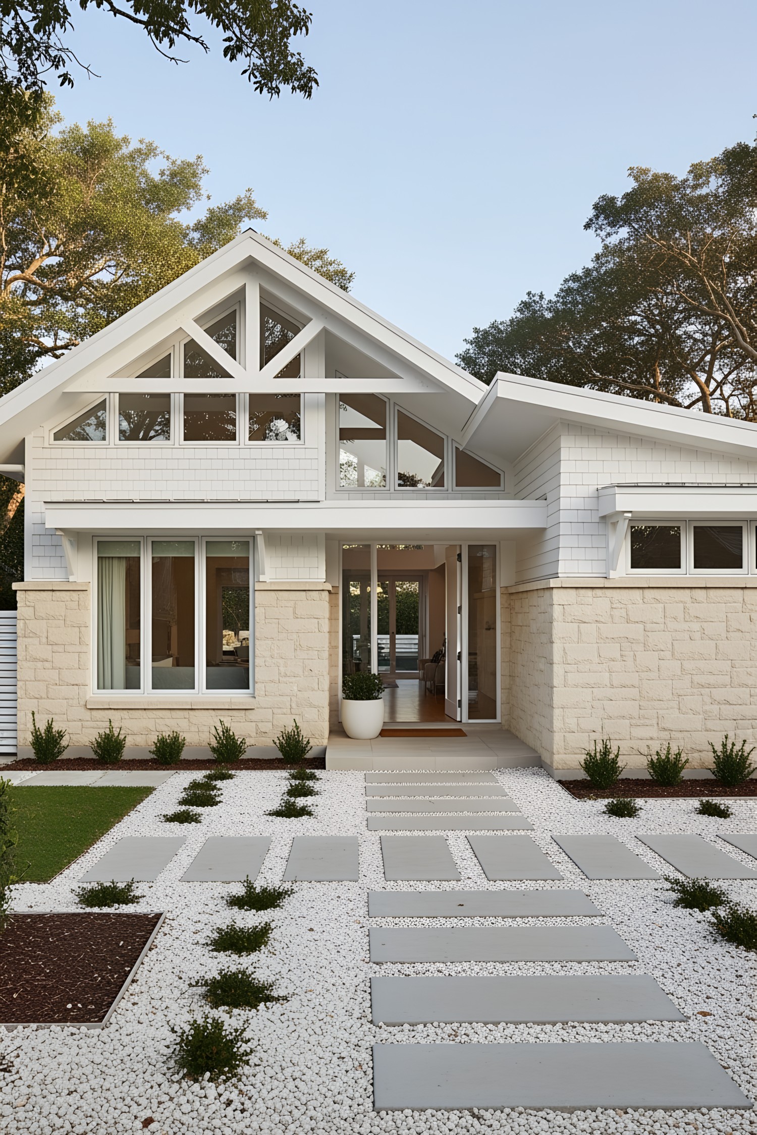 Modern coastal house with stone façade and geometric pathway